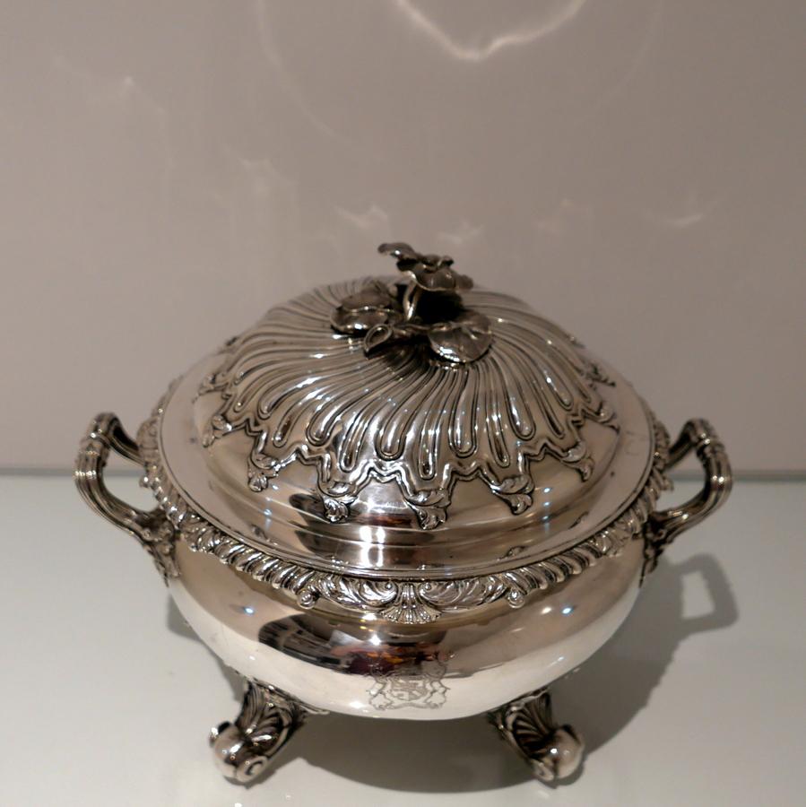 A fine and extremely good quality George IV large circular soup tureen decorated with superb naturalistic feet and handles. The bulbous bowl is plain formed in design and is mounted with a shell and gadroon decorative wire border. The detachable