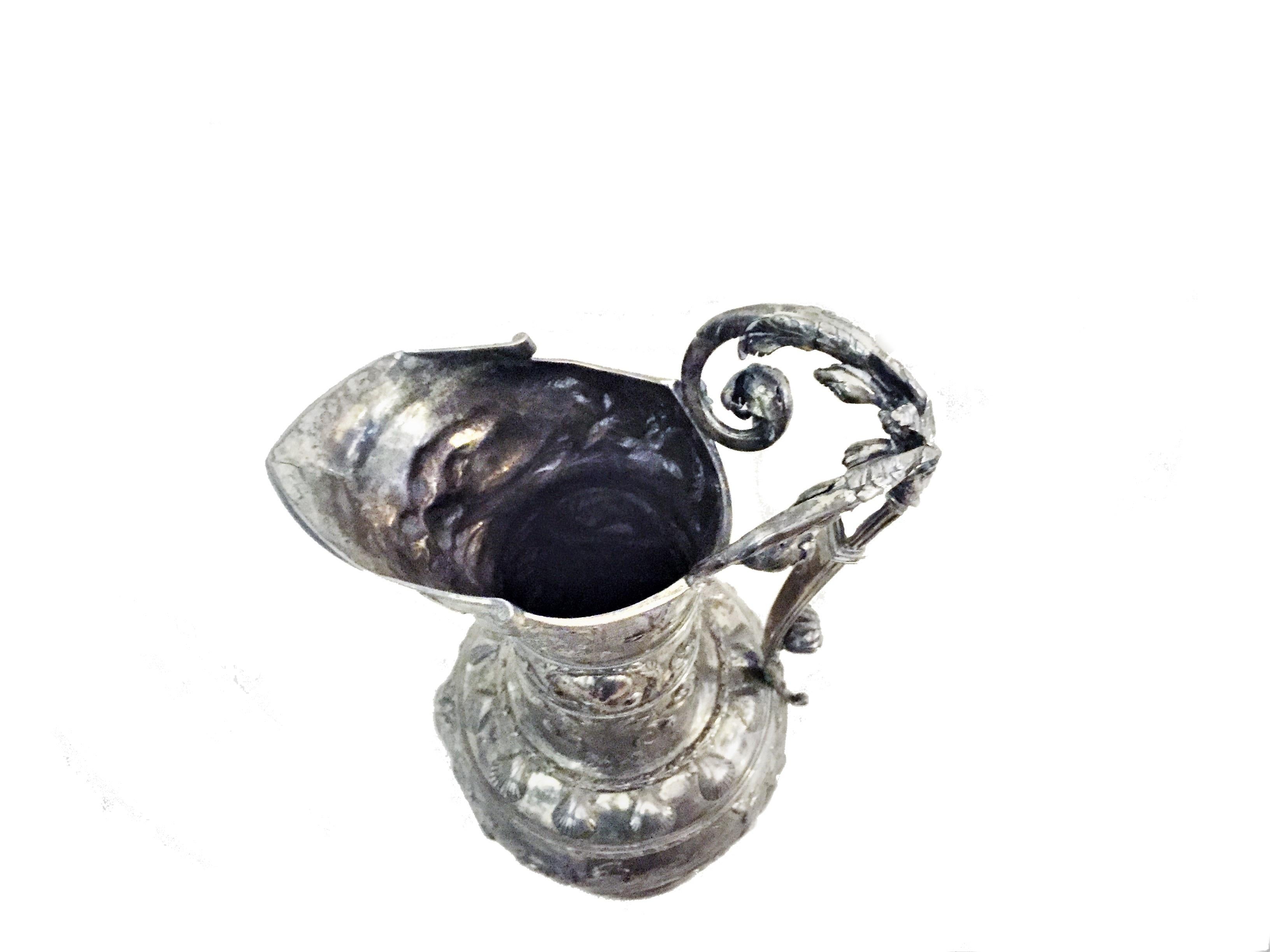 This amazing silver wine jug in perfect German Baroque style of the 17th century was actually finely crafted in the repoussé and chasing techniques at the end of 19th century. Though unmarked, clearly it is a work of a master silversmith.

The