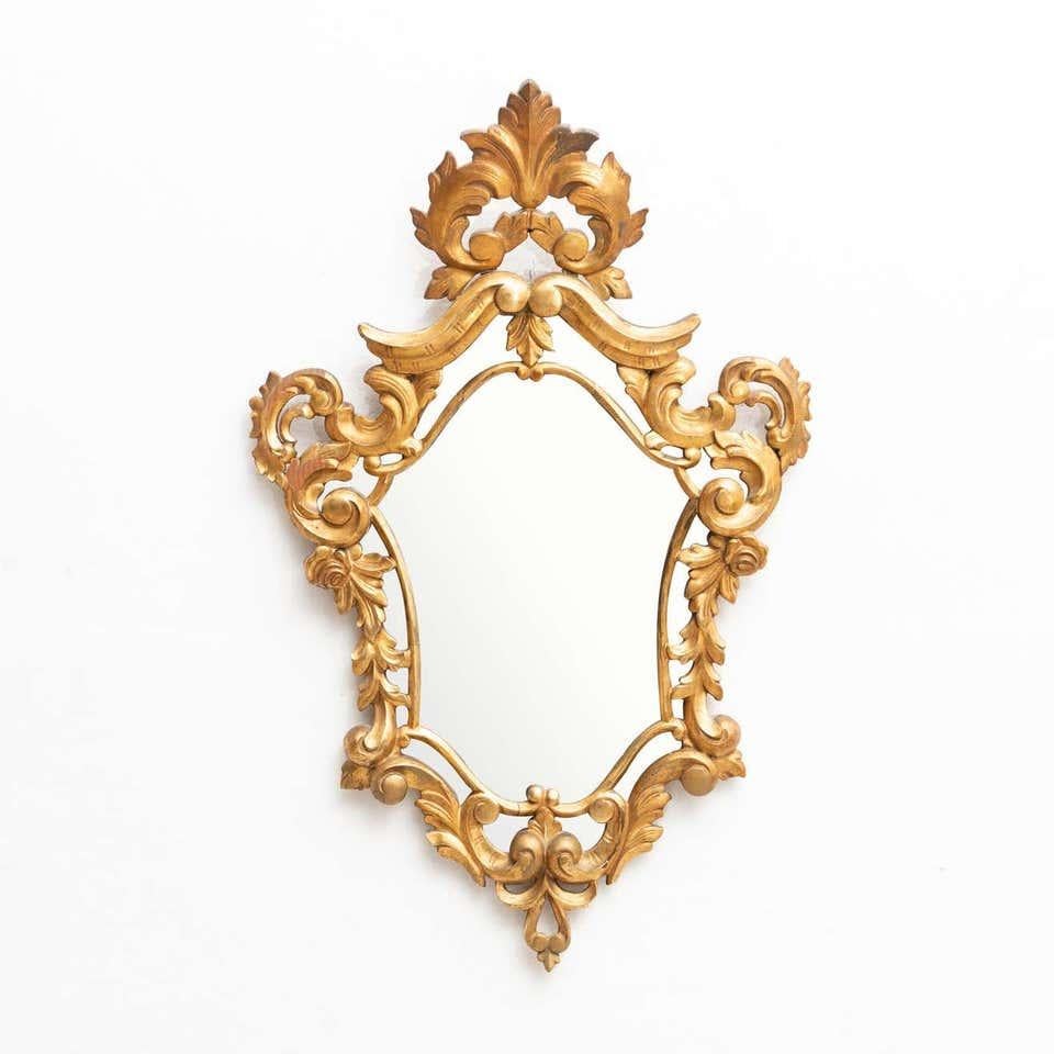 Embrace the timeless elegance of this early 20th century French antique gold cornucopia mirror, a stunning piece that will add a touch of refined beauty to your interior. Crafted in France, this exquisite mirror features intricate detailing and a