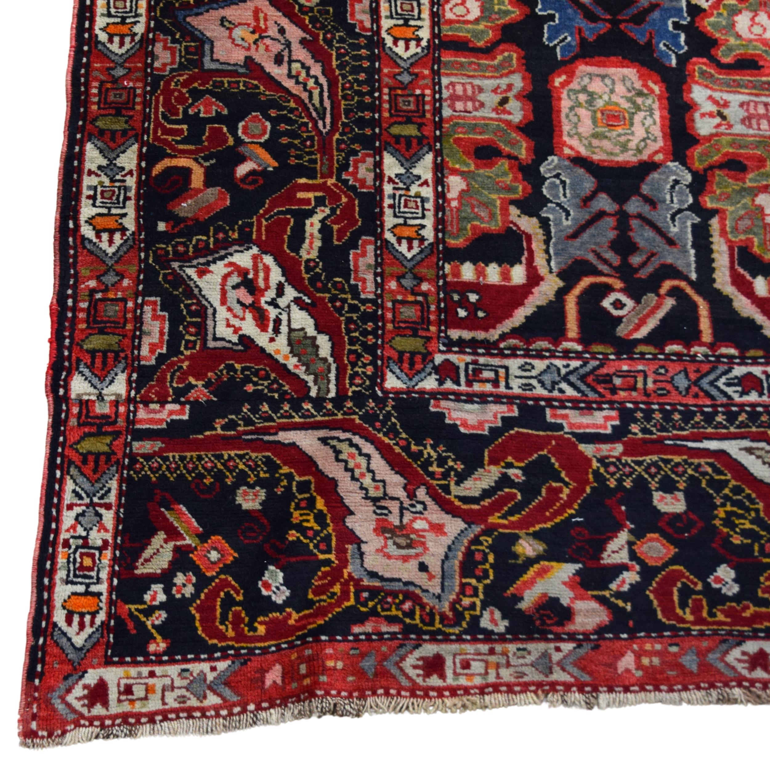 The carpet attracts attention with its rich and complex patterns. Geometric and floral motifs stand out on the carpet, where red, black, beige and green tones dominate. There are more intense and detailed patterns on the edge borders of the carpet.