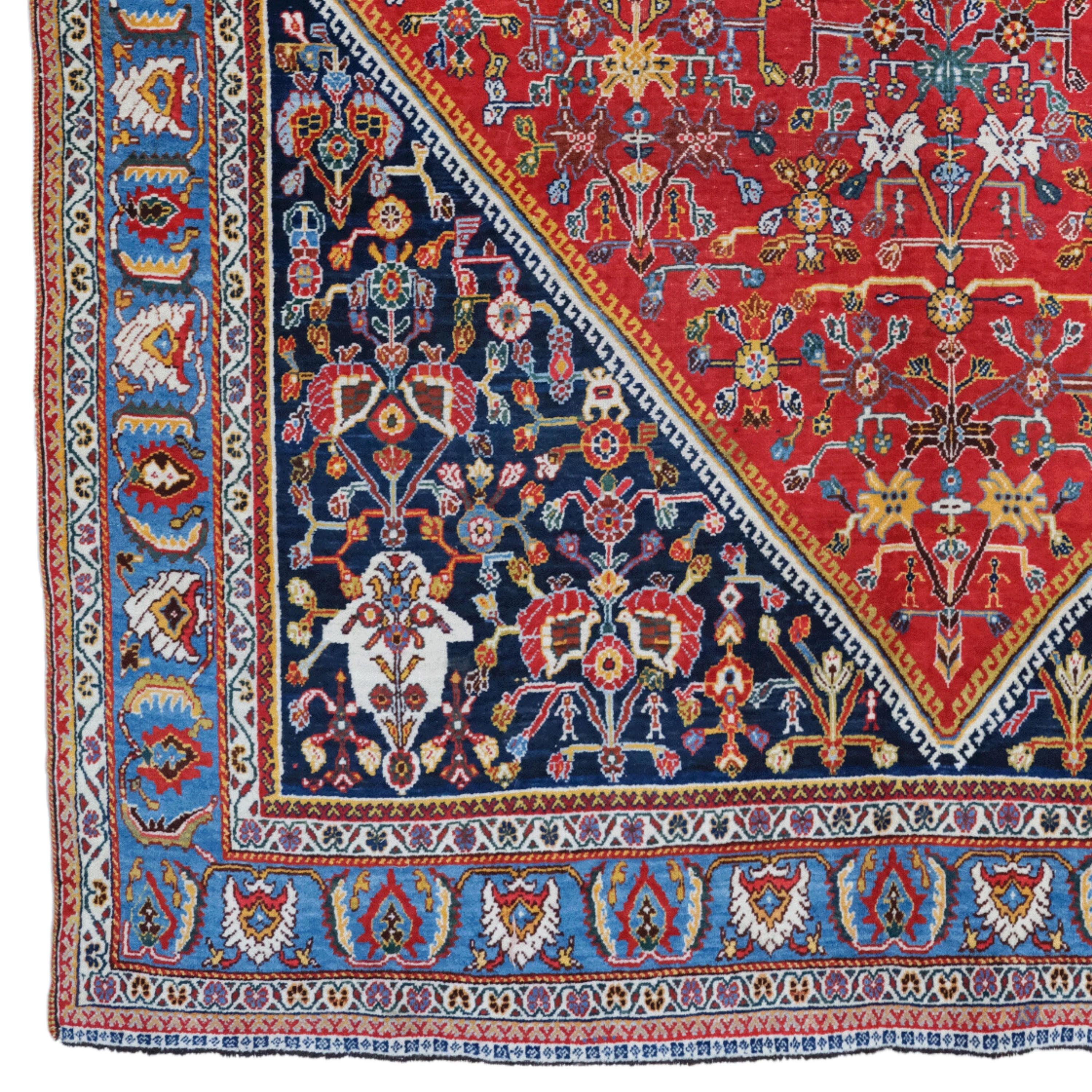This late 19th-century antique Khamseh rug is notable for its rich colors, intricate pattern and hand-woven craftsmanship.

Pattern and Colors: This rug is decorated with an intricate pattern in deep shades of red and blue. Traditional Khamseh