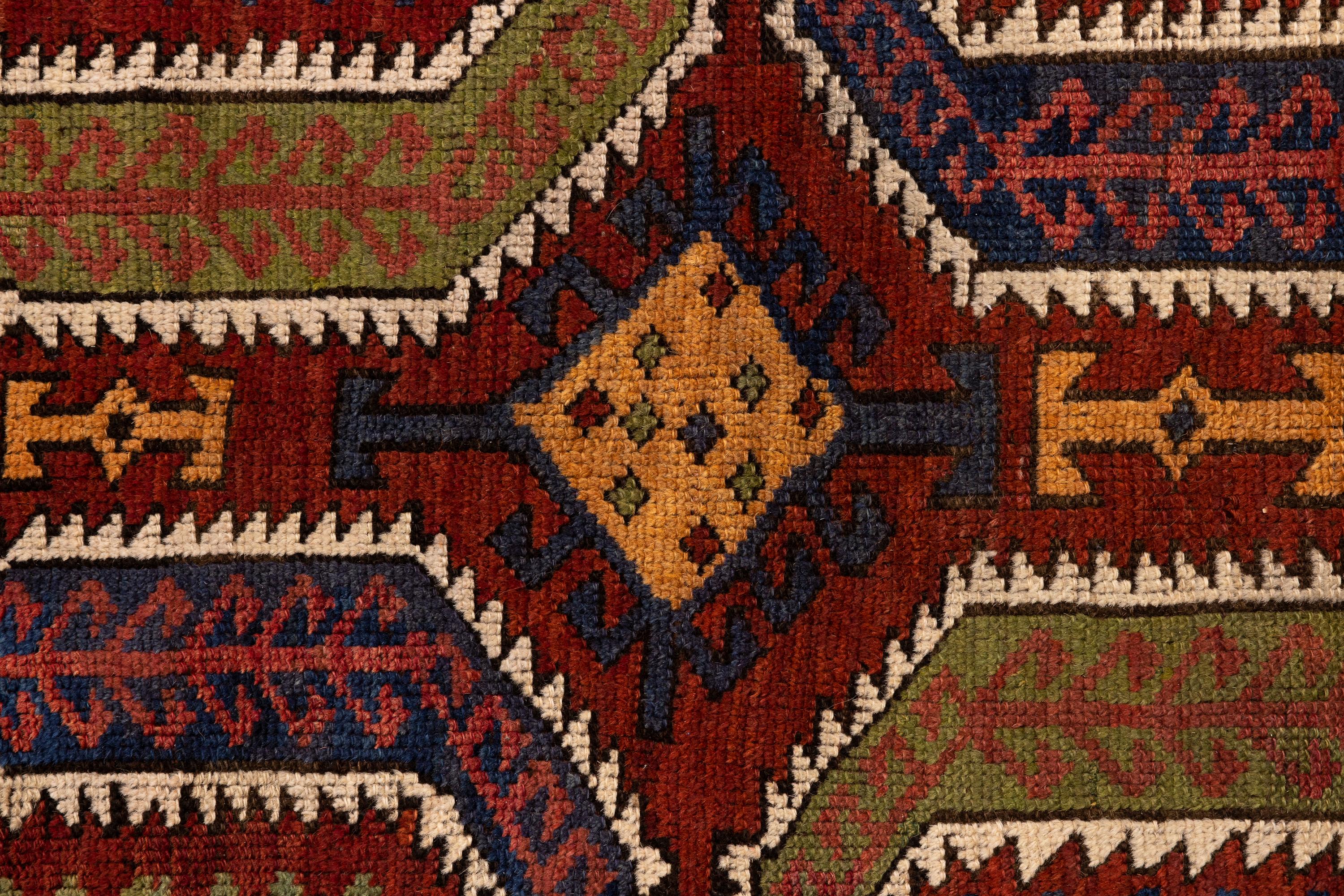 Konya – Central Anatolia

Antique Konya Yastik with solid and vibrant colours. The rug features an intricate design with slightly asymmetrical geometric patterns. The predominant colours are earthy red, blue, yellow, and green. The design details