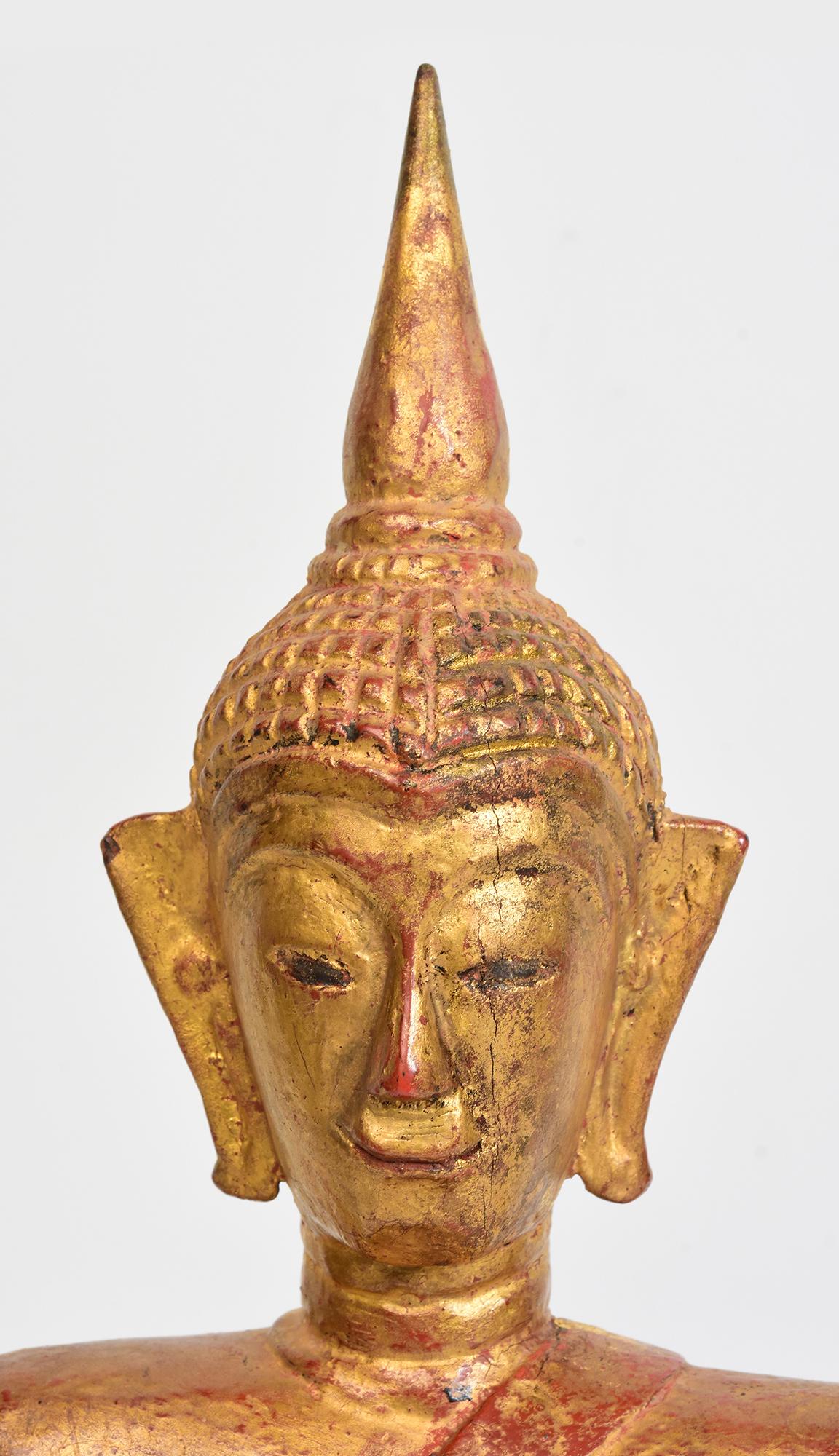 Lanna Thai wooden Buddha sitting in Mara Vijaya (calling the earth to witness) posture on a base, with gilded gold.

Age: Thailand, 19th Century
Size: Height 40.8 C.M. / Width 14 C.M. / Depth 12.1 C.M.
Condition: Nice condition overall (some
