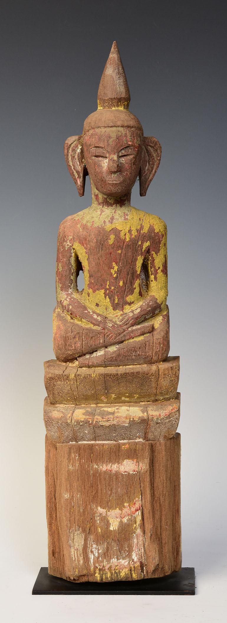 Laos wooden Buddha sitting in Mara Vijaya (calling the earth to witness) posture on a base.

Age: Laos, 19th century
Size: Height 49.6 C.M. / Width 13 C.M.
Size including stand: Height 51.5 C.M.
Condition: Nice condition overall (some expected