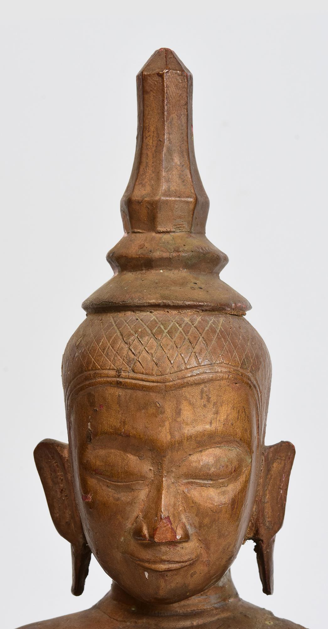 Laos wooden Buddha sitting in Mara Vijaya (calling the earth to witness) posture on a base.

Age: Laos, 19th Century
Size: Height 38.3 C.M. / Width 15 C.M. / Depth 10.4 C.M.
Condition: Nice condition overall (some expected degradation due to its