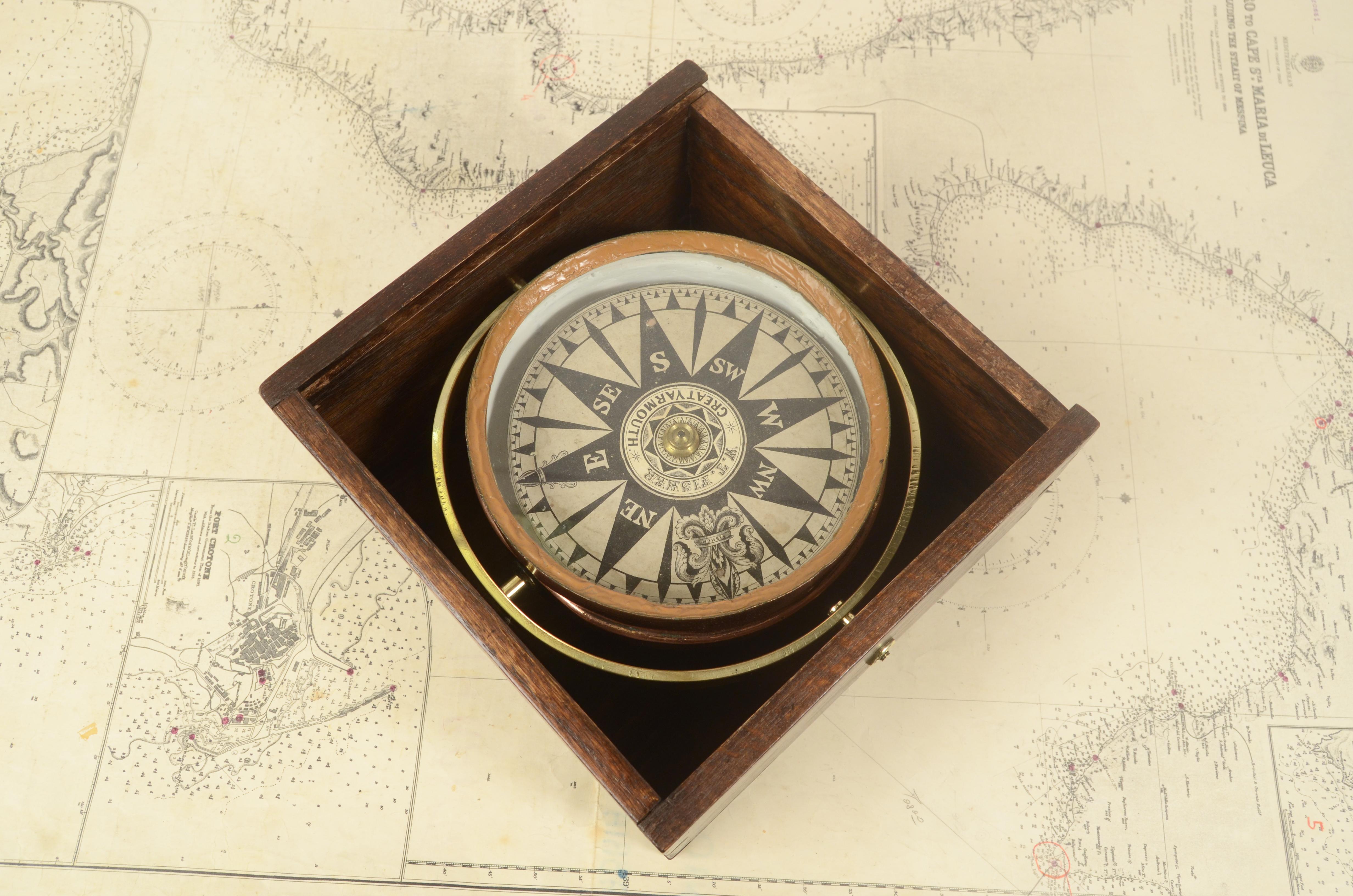 Compass in its original wooden box with slot lid. Signed W. T. FISHER Great Yarmouth, mid 19th century. The compass is made up of a copper container with a lead and glass counterweight on the bottom of which is fixed a metal stem on which the eight