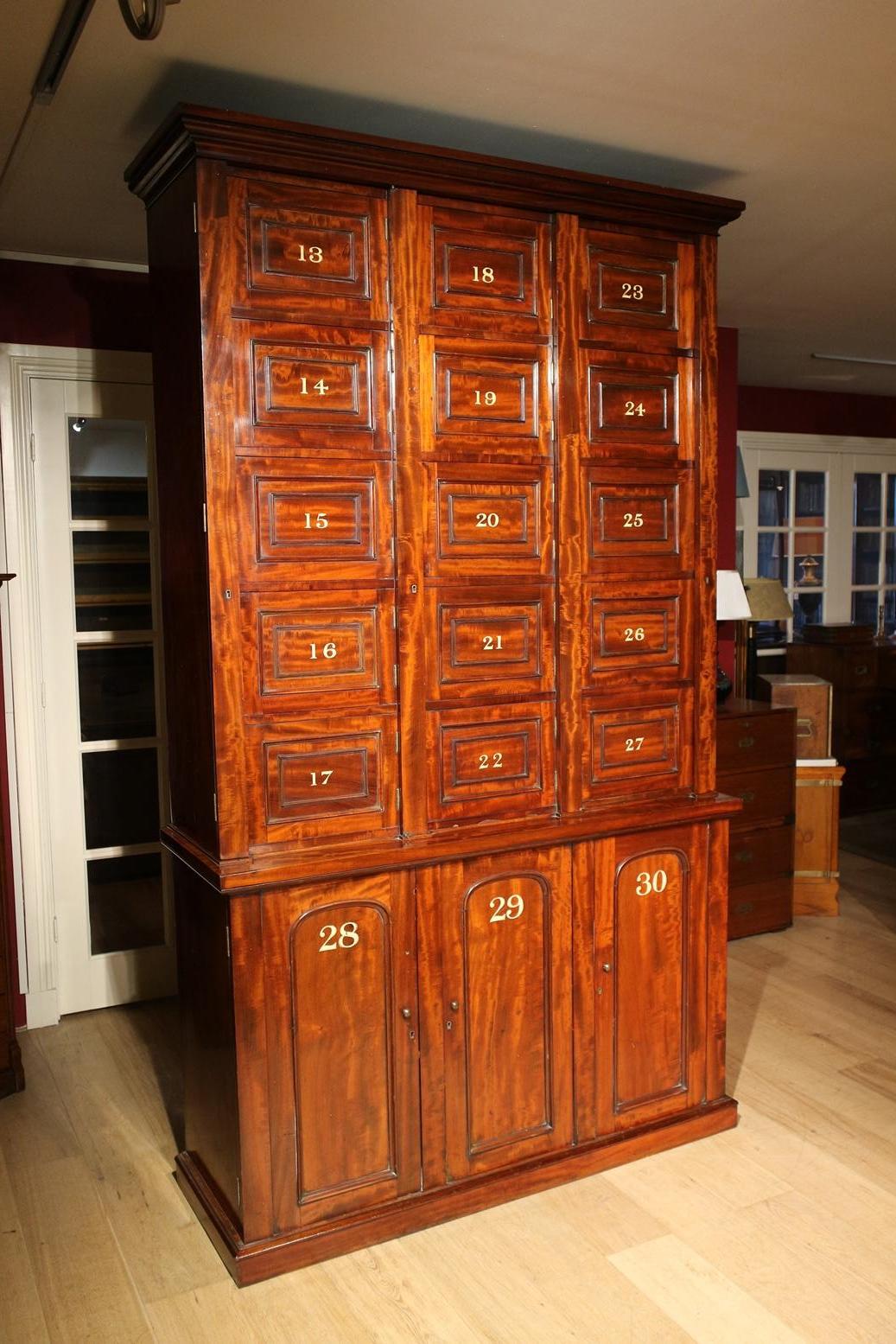 Very special antique mahogany locker cabinet from an English boarding school. The cabinet is completely original and in perfect condition. Nice warm mahogany color. Impressive quality. Unique item.

Origin: England

Period: Approx. 1860

Size