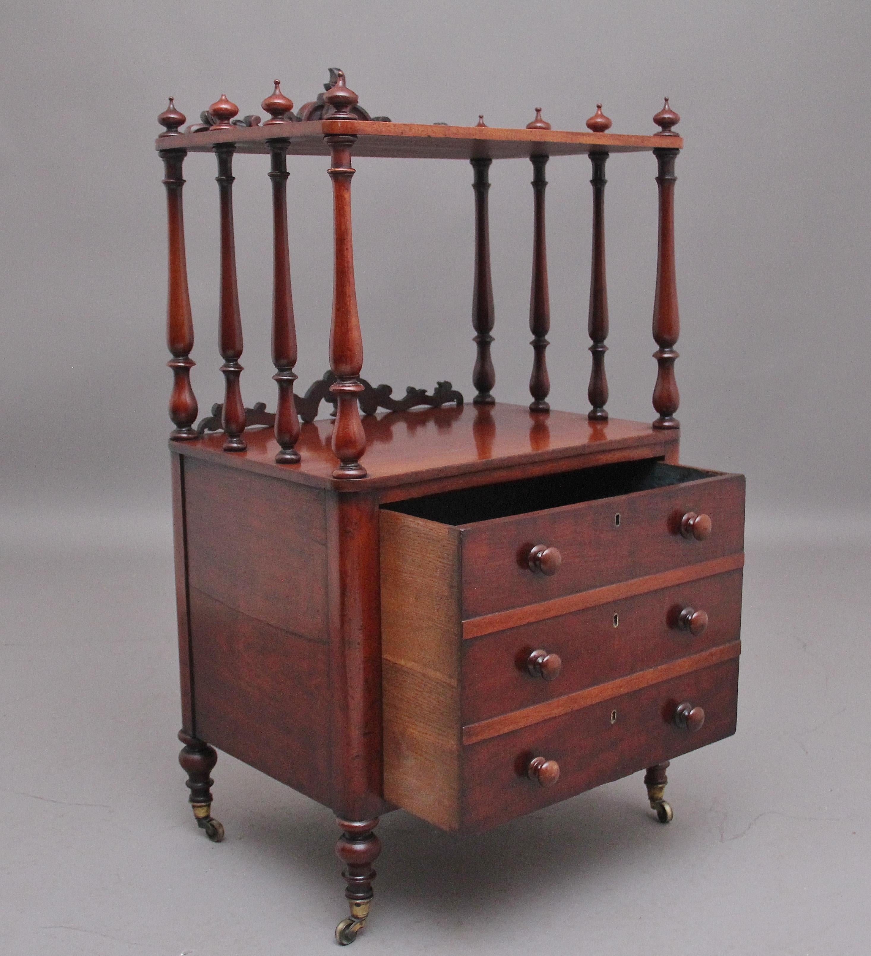 19th Century mahogany whatnot with cellarette, the top shelf supported by elegant turned columns and having decorative turned finials on the top shelf, with bold carved decoration and the same style carved decoration below, the base section having a