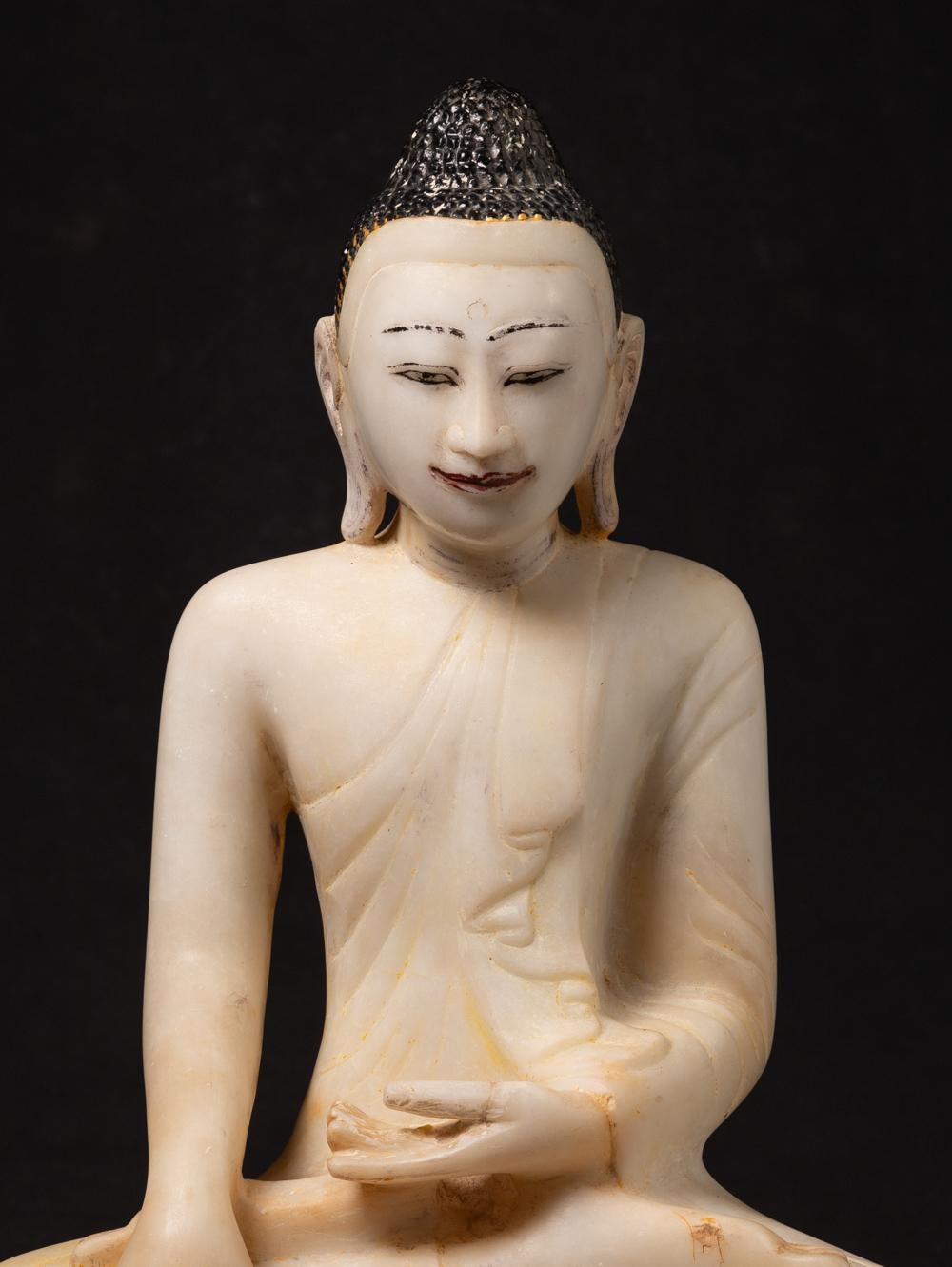 This antique marble Burmese Buddha statue is a magnificent representation of artistry and Buddhist devotion. Crafted from marble, it stands at an impressive height of 57.5 cm and has dimensions of 40 cm in width and 23.5 cm in depth. 

The statue is