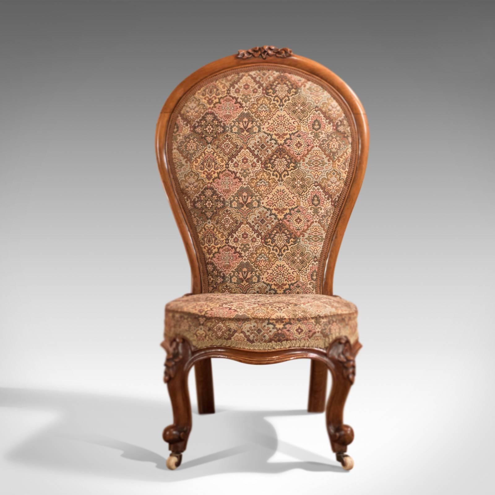 This is a Regency, antique nursing chair dating to circa 1820.

The quality walnut frame glows in warm honey hues with depth in the aged patina and tonal qualities of this period piece.

Riding upon the original ceramic castors, the splayed