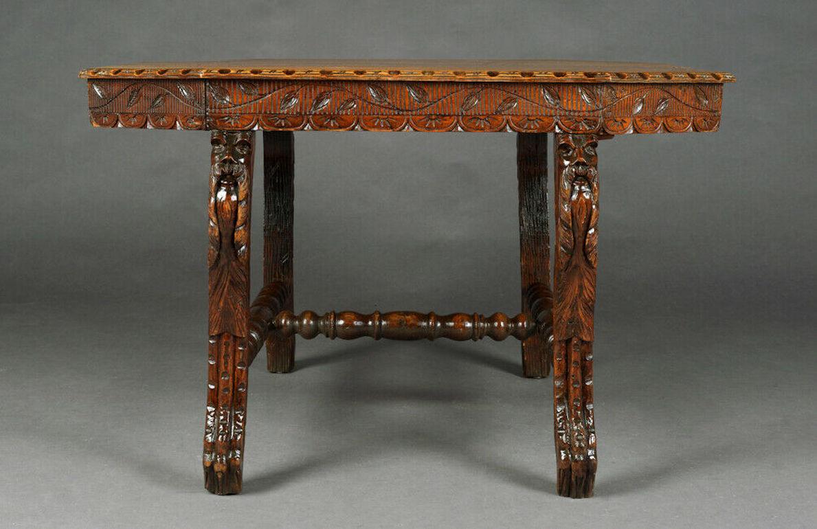 Solid oak, partially veneered. Octagonal shaped frame on four curved, strongly carved legs. Slightly protruding top plate.

Excellent warm patina grown over decades. Age-related use traces.
Originates from a Berlin estate.