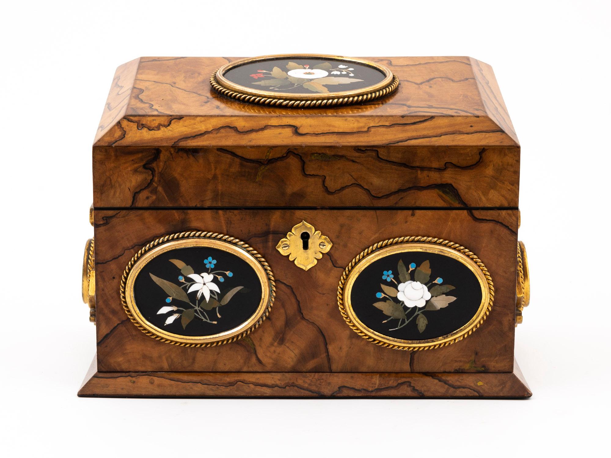 This Classic Antique Feathered Olivewood Stationery Box is attributed to famous cabinet makers Betjemann & Son.

This stunning small Stationery Box has floral sprays made from Ashford marble in the Pietra Dura style; these are exquisitely framed by
