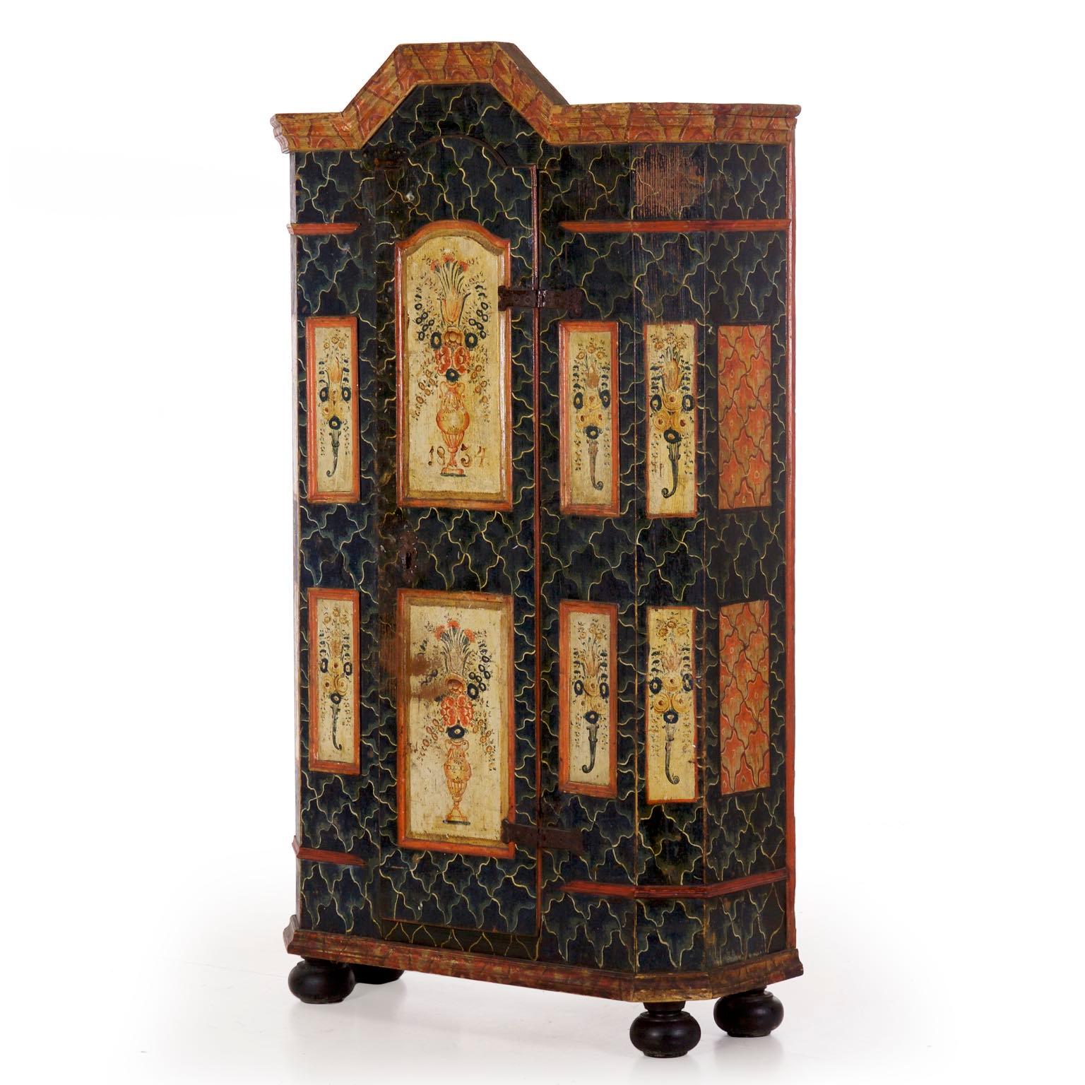 The faceted angular body of this armoire works to relieve the weight of the form, overall being a rather unusual form for its diminutive overall size. It is an object that was carefully constructed such that it would not overwhelm a room. Four