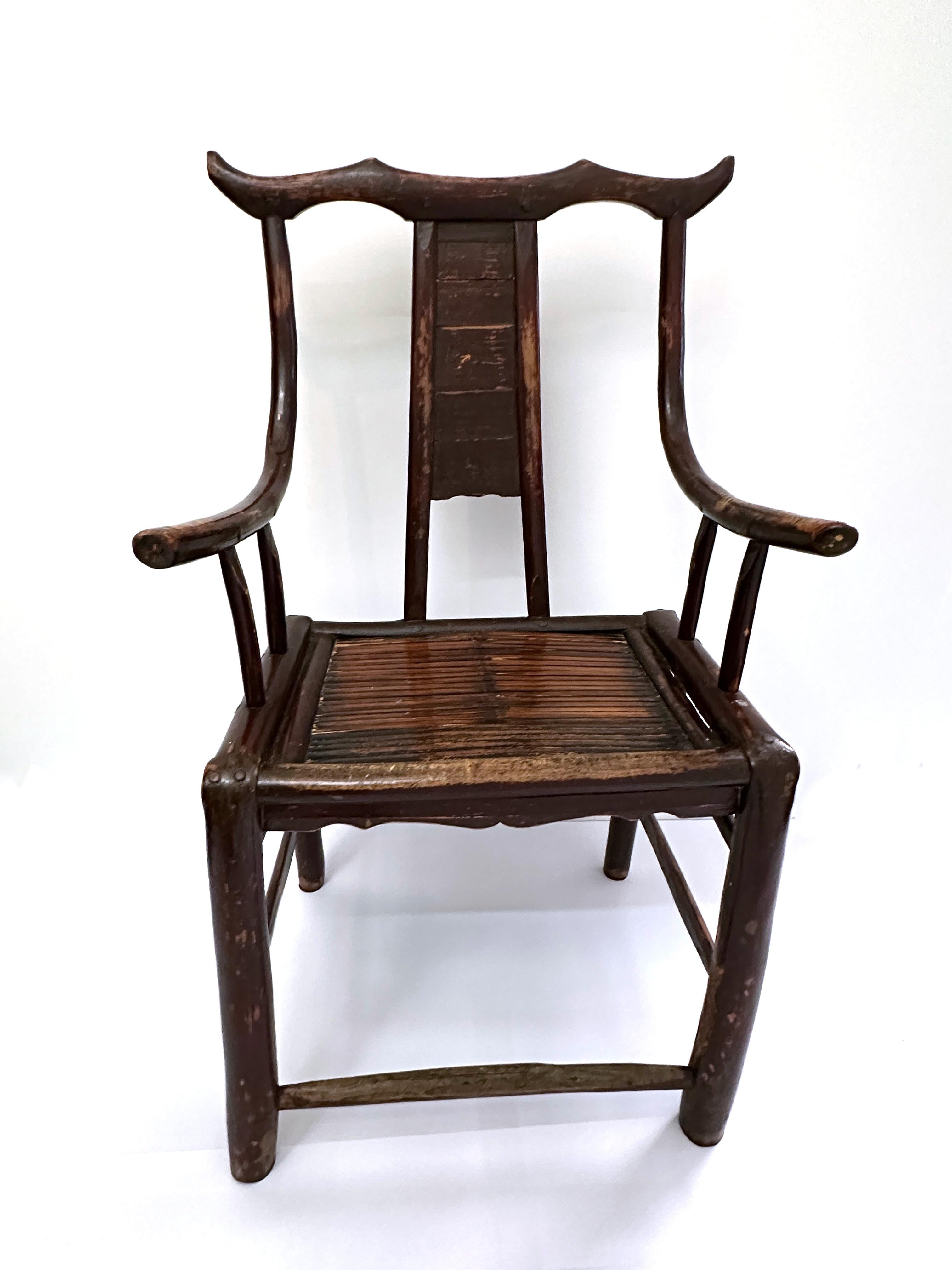 Antique Chinese hand carved wood armchairs with original aged finish and bamboo seat. High back armchairs with a simple yet elegant Ming style. Natural Patina. Circa 1800s.

Property from esteemed interior designer Juan Montoya. Juan Montoya is one