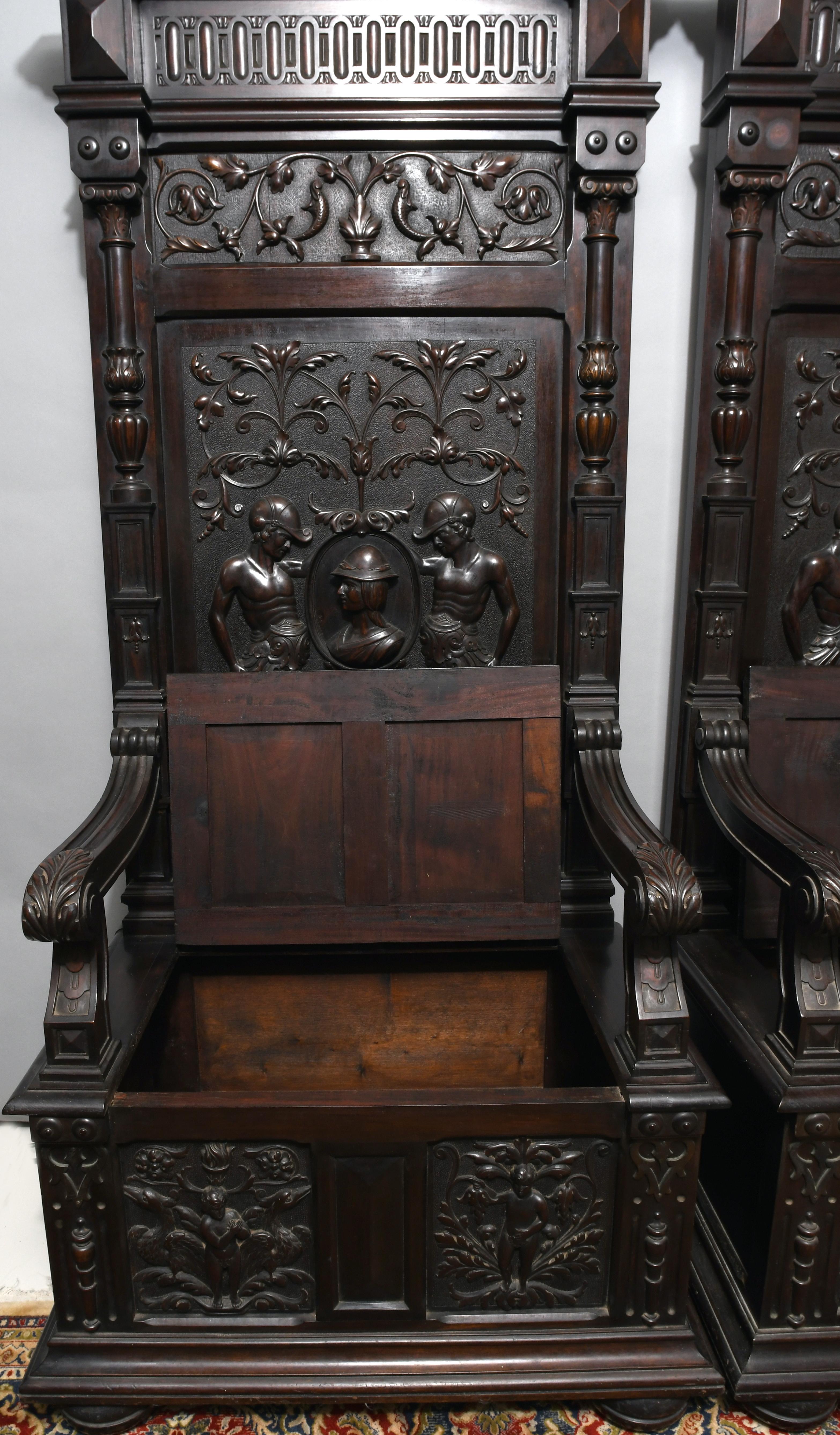 These thrones are typical examples of the Renaissance Revival era. They show deep carving, reliefs of mythological figures with Greek helmets, and foliage; plus molded cornices and fine spindles. There are a secret compartment under the lift lid
of