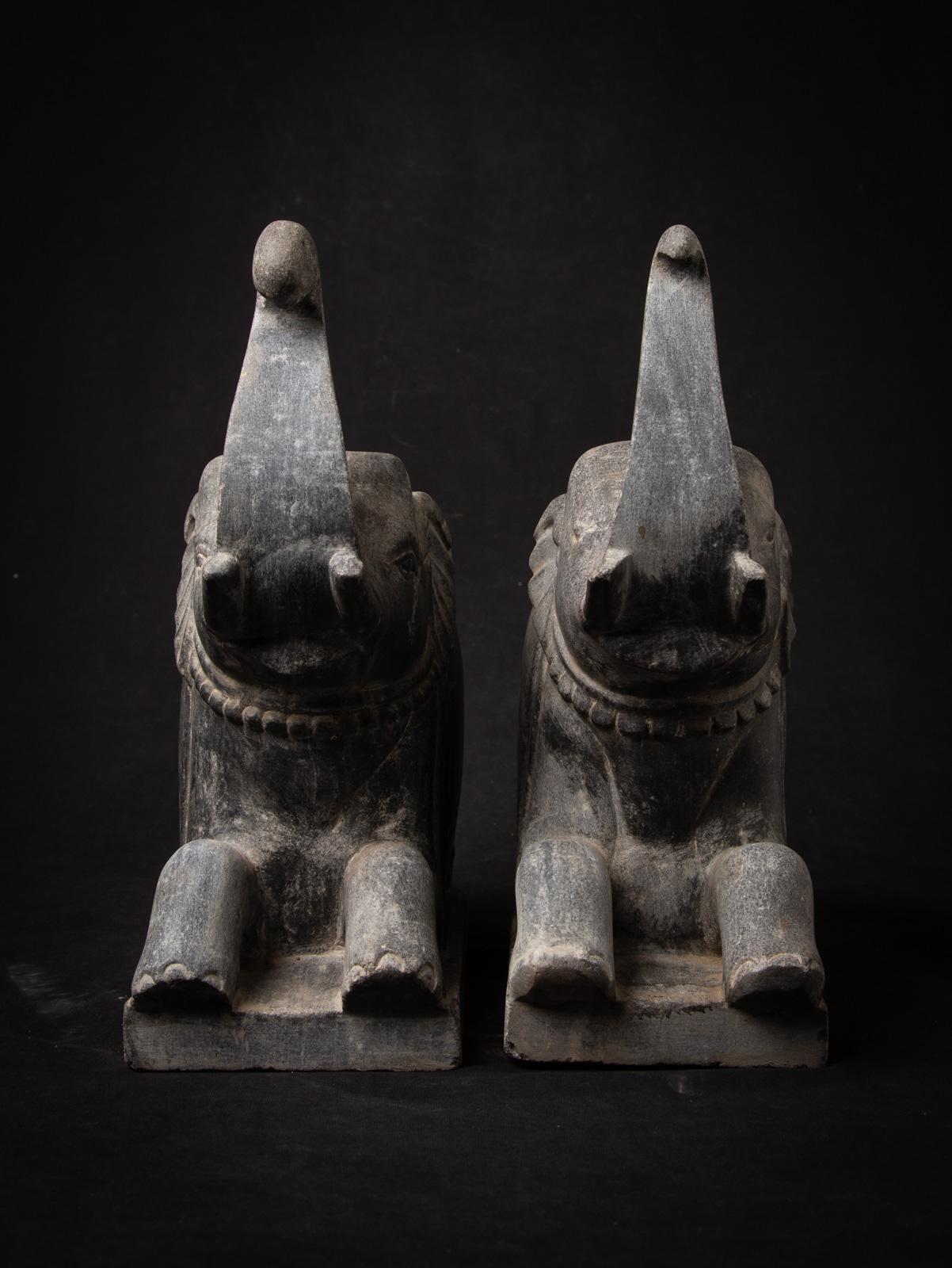 This antique pair of stone Indian temple elephants, originating from a historic temple in India, is a remarkable representation of traditional craftsmanship and spiritual symbolism. Carved from durable granite stone, these statues embody strength,