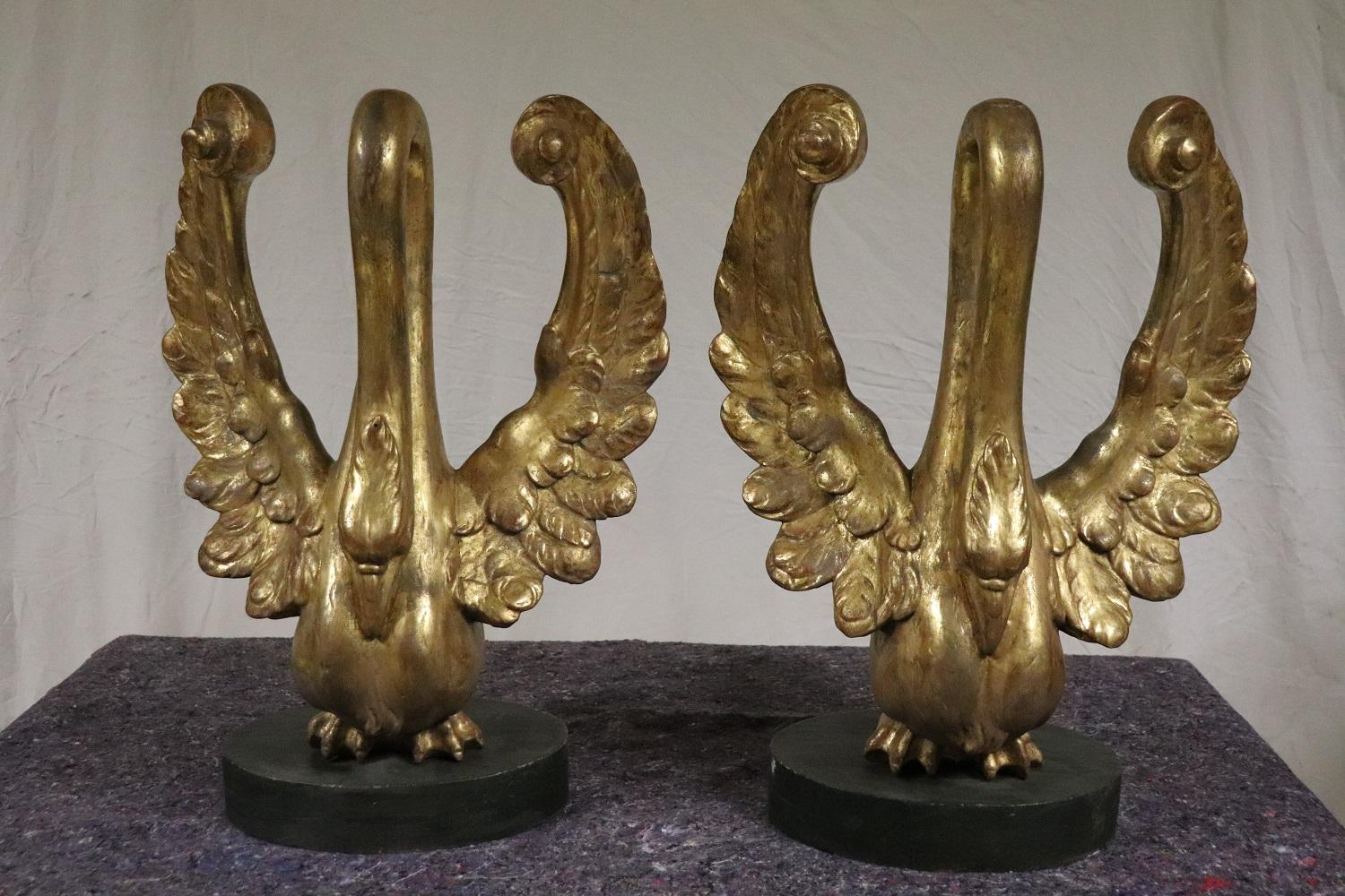 Rare antique pair of swan sculpture. If you love this animal you will need to add these two sculptures to your collection! They are fantastic large in size made of carved wood and gilded with gold leaf. The gold has acquired a beautiful old
