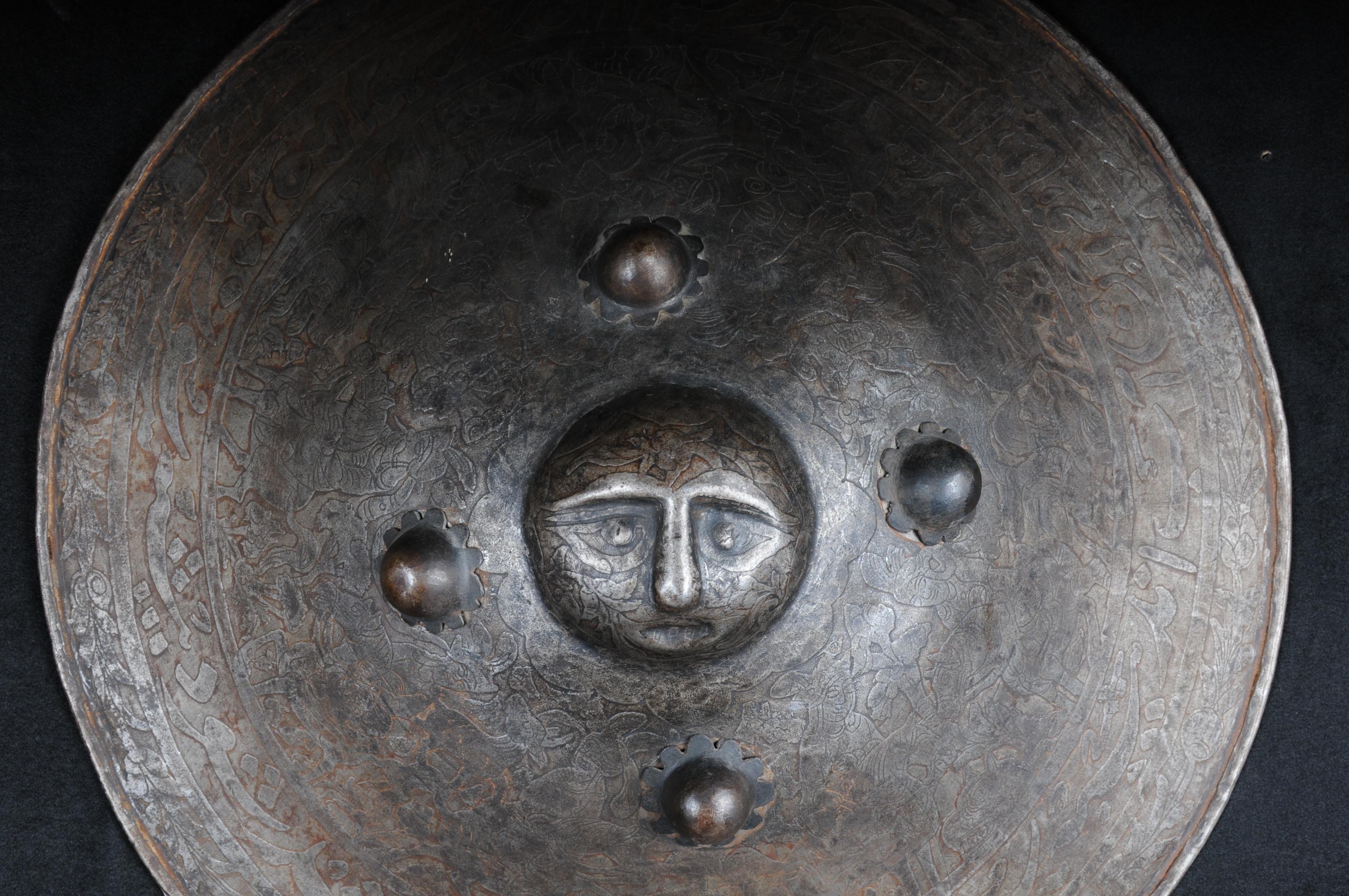 Antique Persian battle shield, 19th century.

Impressive iron battle shield with Persian ornaments in solid metal. Heavily arched carcass relief-like face.

Fine etched work. 

(V-119).