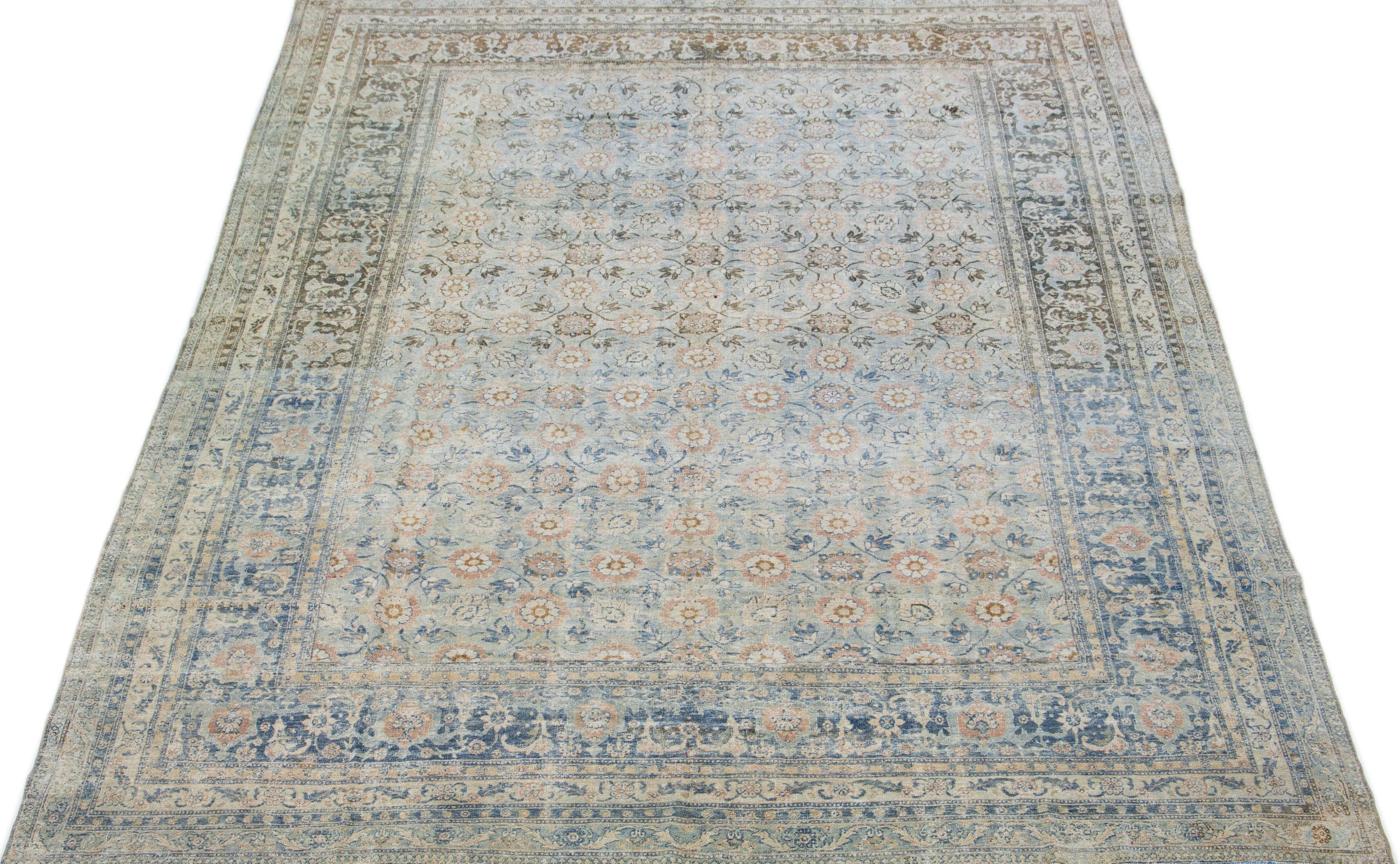 This stunning hand knotted Persian Tabriz wool rug has a light blue field and a gorgeous traditional Allover floral design featuring a peach accent. An antique masterpiece, this rug is a magnificent piece of art.

This rug measures 9.4