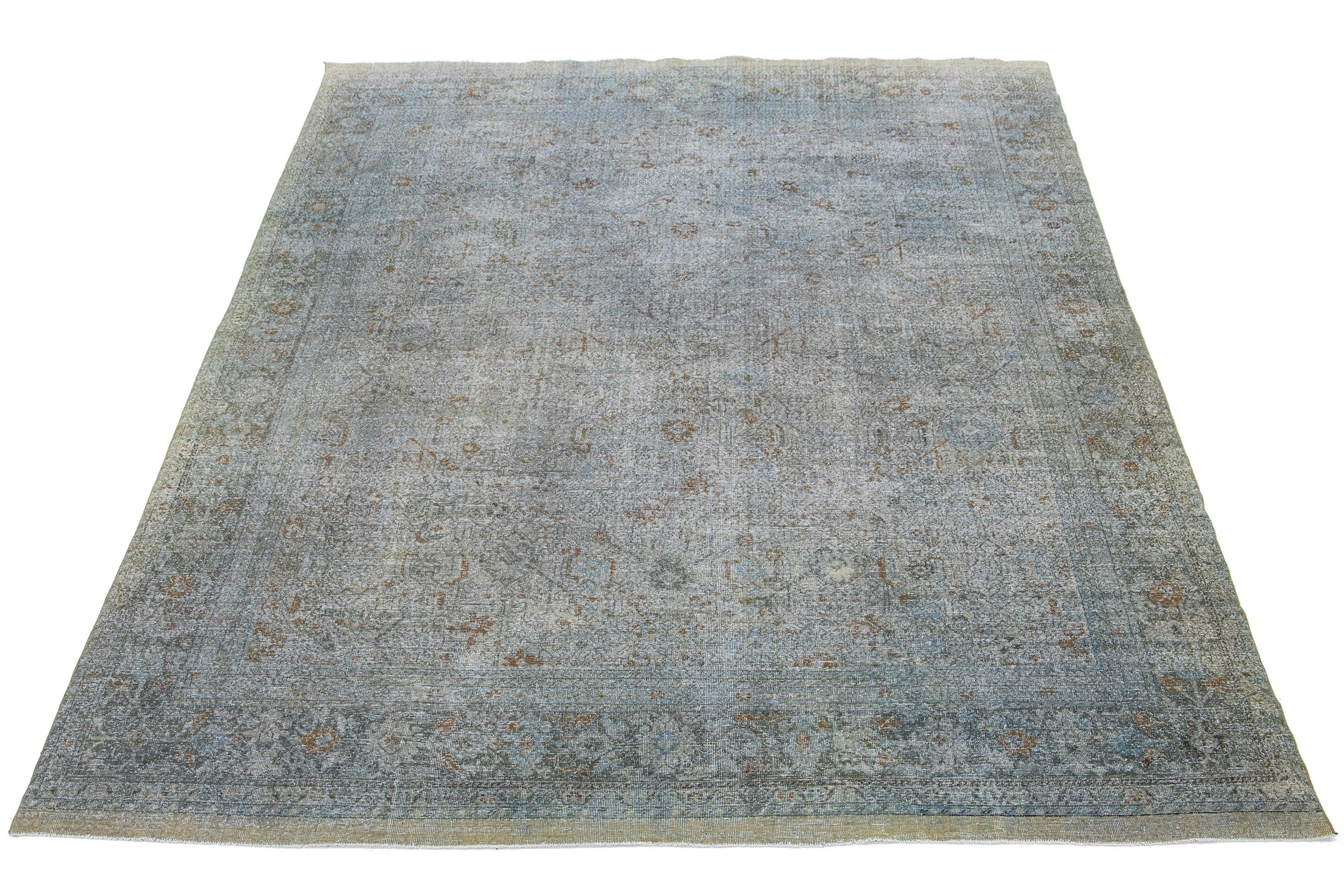 The handcrafted Persian Tabriz wool rug features a beautiful traditional floral pattern. The alluring contrast between the gray background and the distressed beige, rust, and brown floral design further enhances its beauty.

This rug measures 9'7
