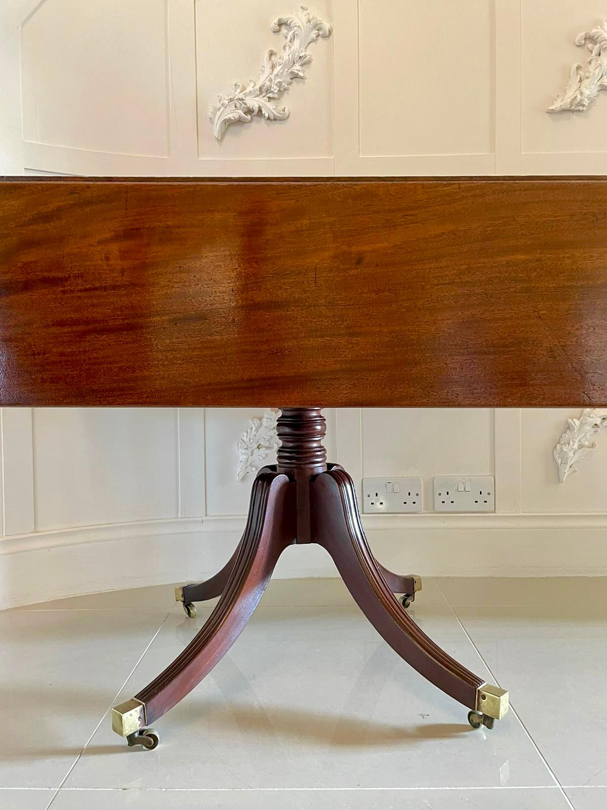 19th century antique Regency mahogany pembroke table having a beautiful quality top with two drop leaves and a reeded edge, one drawer to the frieze and supported by a delightful turned column and raised on four elegant reeded sabre legs with brass