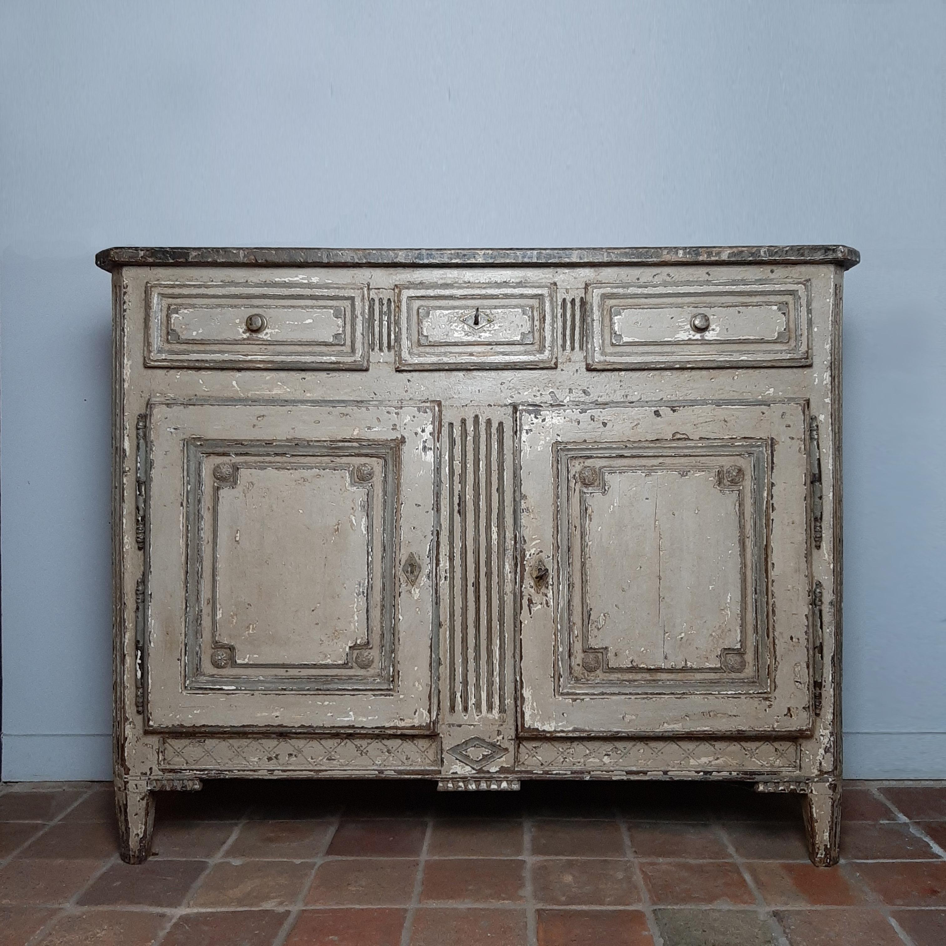 Beautiful antique sideboard from the 19th century, in Louis XVI style. This French cupboard is made of oak and is finished in a beautiful aged greyish beige patina with a hint of green and on the top a marble look finish. The inside is made of
