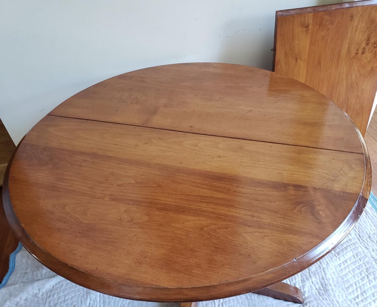 Late 19th century antique solid maple pedestal kitchen table.
Beautiful Round Kitchen table, in good stable condition. Table expands to an oval shape using the matching leaf that is included, and pictured. Diameter of table (without leaf) is