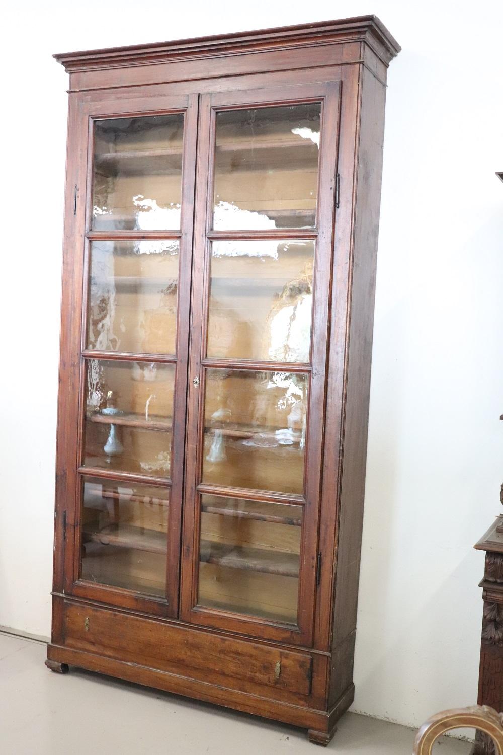 Italian antique in solid poplar wood bookcase. Very linear and essential perfect to be combined even in a modern home. In the lower part one comfortable drawer. Ample useful internal space equipped with seven shelves. The solid internal shelves can