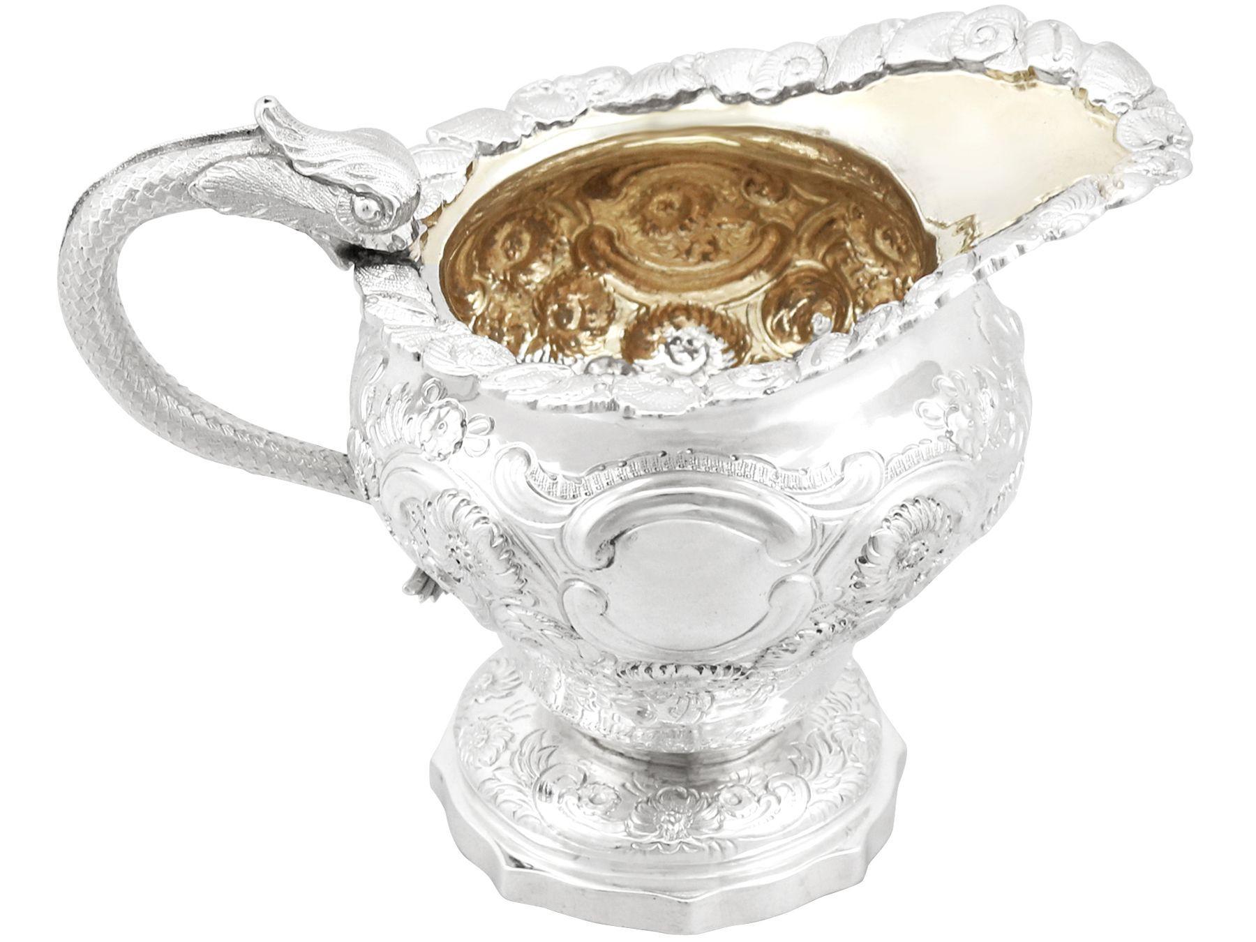 An exceptional, fine and impressive, antique William IV English sterling silver cream jug; an addition to our silver teaware collection.

This exceptional antique sterling silver cream jug has an baluster shaped form onto a domed pedestal and an