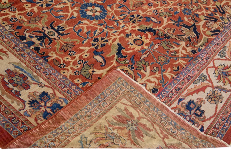 Beautiful antique Persian Sultanabad hand-knotted wool rug with a rust-red color field. This piece has a beige-designed frame and multicolor accents in a gorgeous all-over floral pattern design.

This rug measures: 14'7
