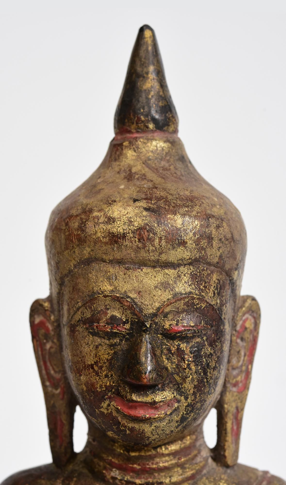Antique Thai wooden Buddha sitting in Mara Vijaya (calling the earth to witness) posture on a base.

Age: Thailand, 19th Century
Size: Height 24.9 C.M. / Width 19.5 C.M.
Condition: Nice condition overall (some expected degradation due to its