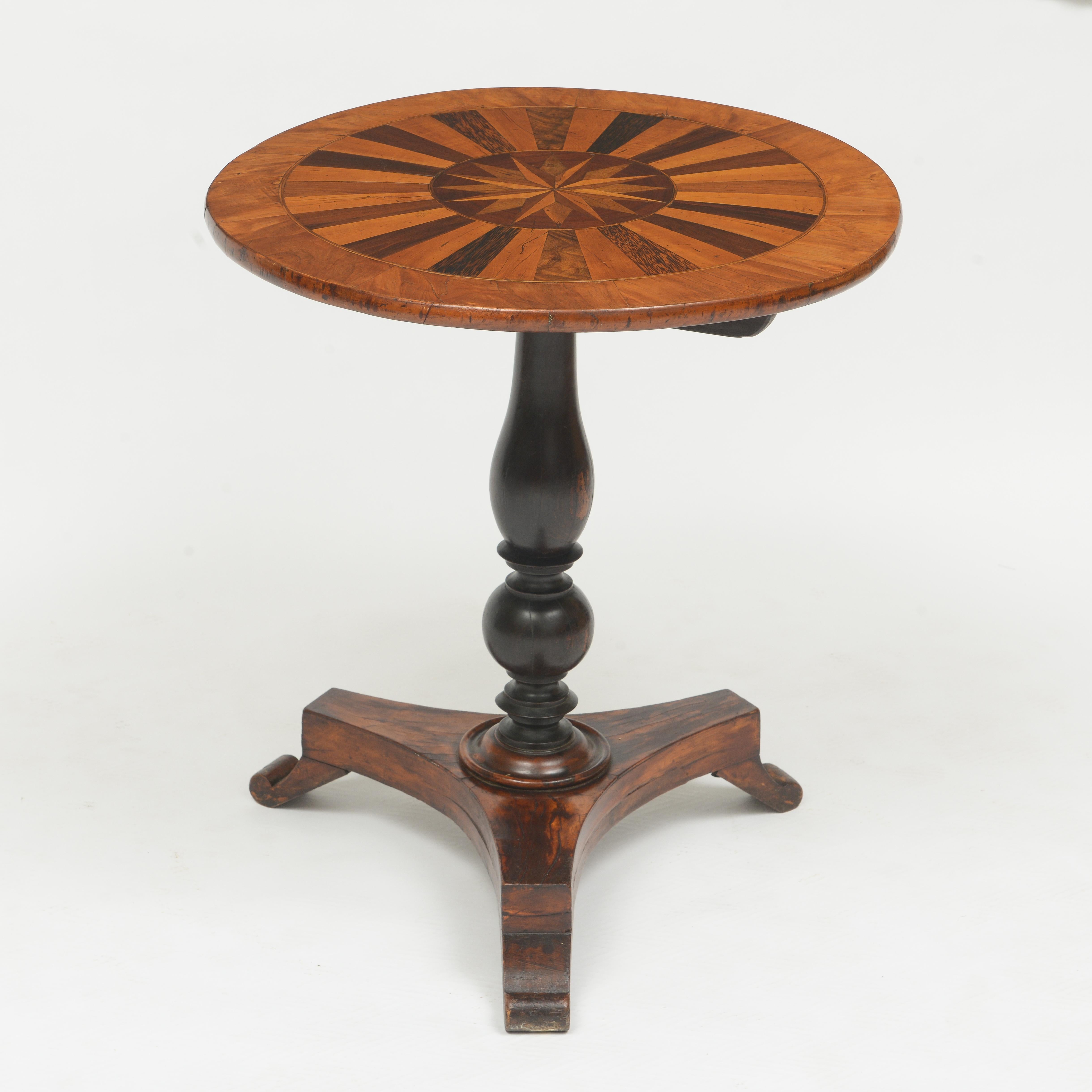 Sample wood top in a star pattern, solid ebony pedestal base with three legs, great color with appropriate patina.

