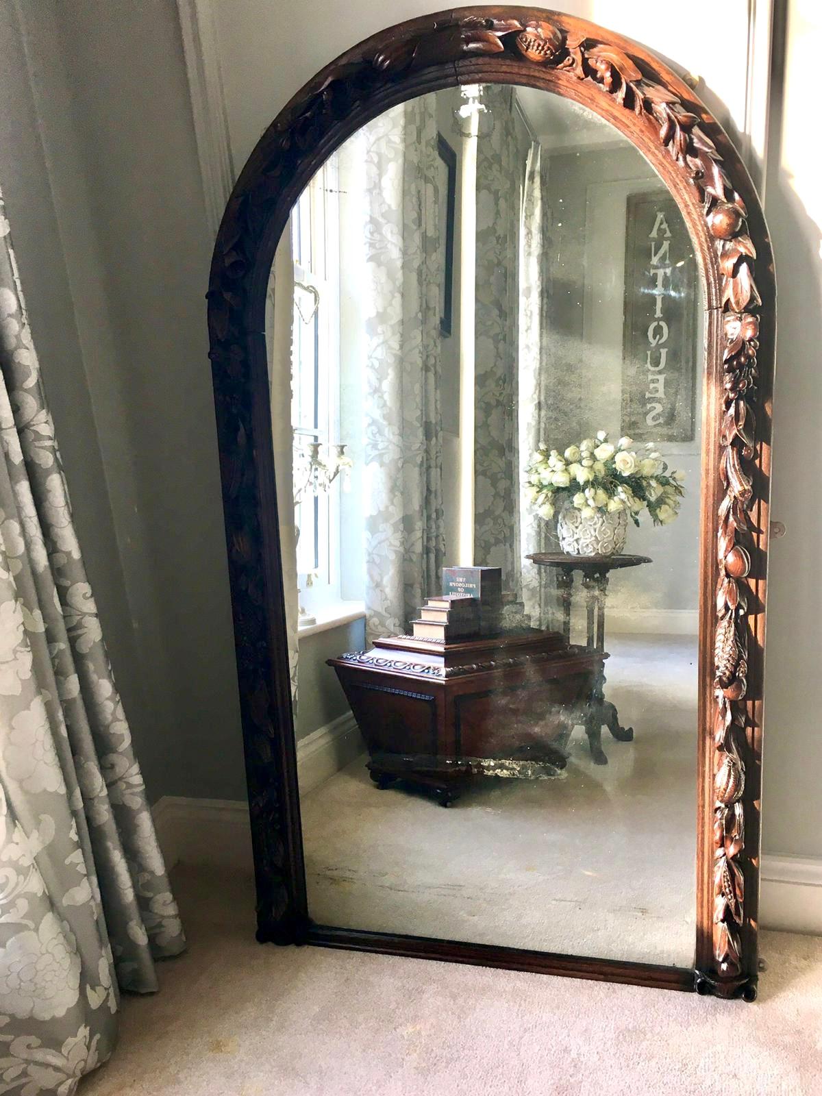 19th century antique Victorian carved oak wall mirror having an arched top and fine carved oak frame depicting various fruits and foliage. The carving is exquisite, the design and expertise being excellent. It boasts its original mirror plate.

A