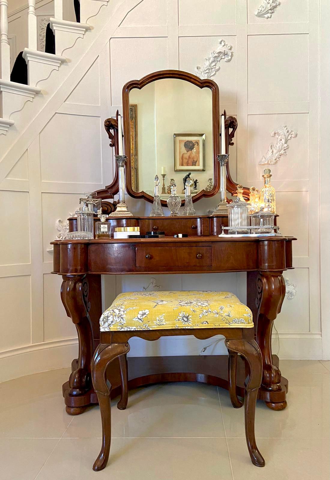 19th century antique Victorian mahogany vanity/dressing table having a beautiful mahogany framed mirror with thumb moulded edge flanked by two quality shaped carved scrolled supports above three working drawers with original turned mahogany knobs.
