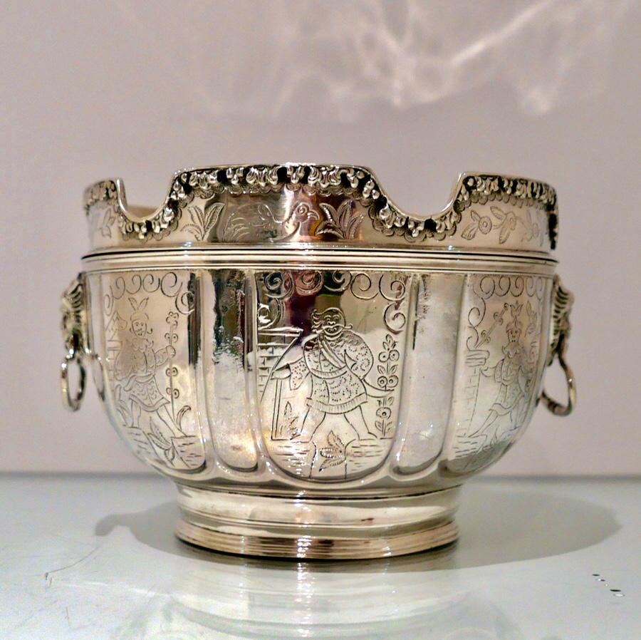 A stylish late 19th century sterling silver Monteith bowl with detachable rim. The centre front is elegantly hand engraved with a ‘wreath’ cartouche and the surrounding panels have beautiful chinoiserie workmanship. The bowl has creative designed