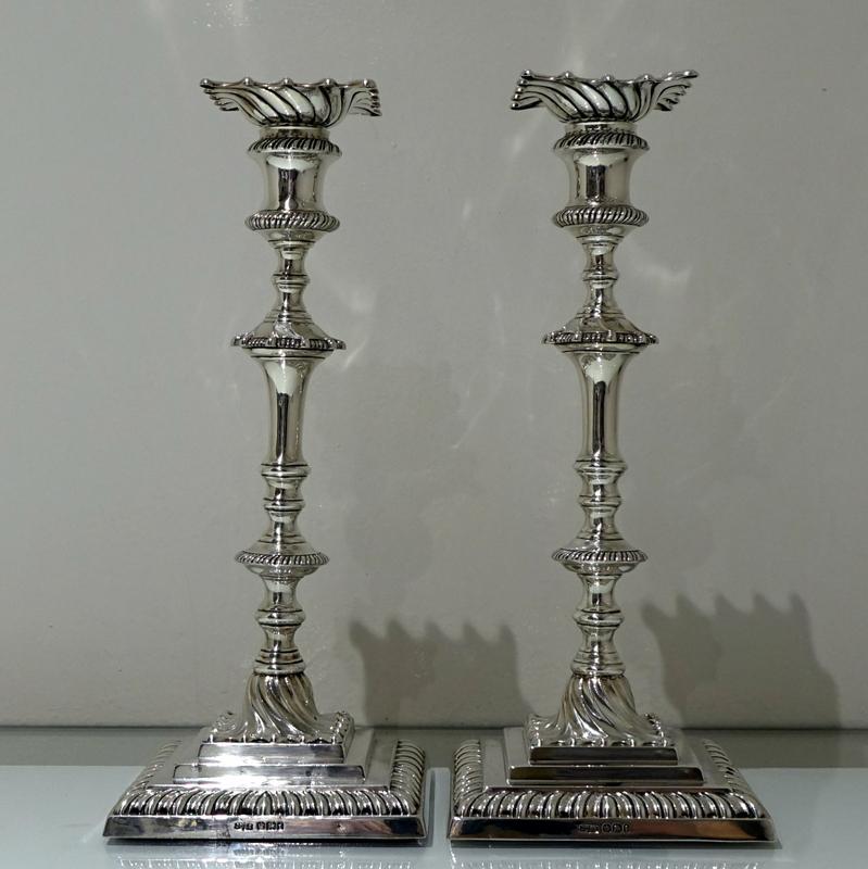 A stunning pair of Victorian silver square based swirl fluted candlesticks. The applied borders are gadroon for highlights and the raised central plinth is “stepped” for decorative lowlights. The stylish nozzles are detachable.

 Measures: Height