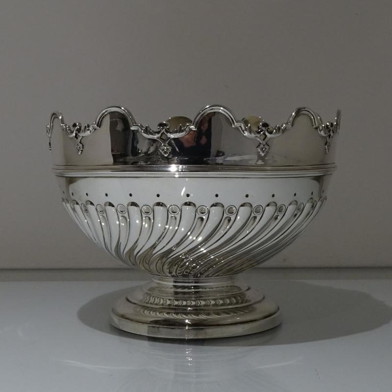 A splendid mid-sized 19th century circular silver rose bowl decorated with elegant spiral fluting to the body. The stylish rim of the bowl is fixed in order for you to use as rose/monteith bowl.

 

Weight: 36.6 troy ounces/1139