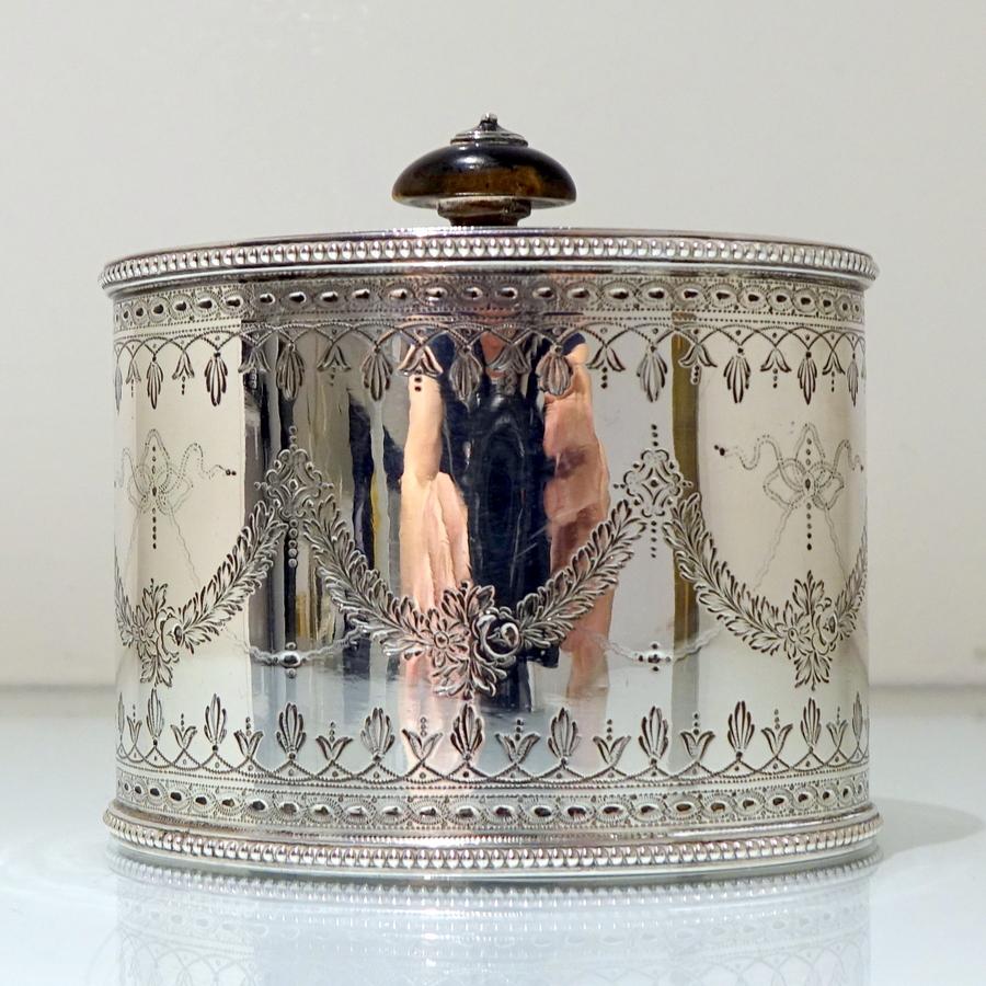 A very sweet oval shaped tea caddy decorated with intricate bright cut engraving to the body which is then sandwiched between two elegant bead borders. The lid has a desirable “flush” hinge and has additional bright cut decorative engraving.

