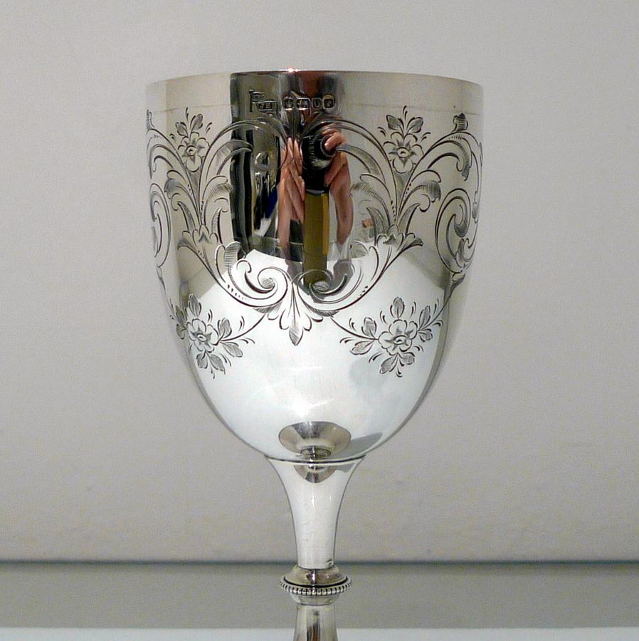 A beautiful Victorian silver wine goblet decorated with a central hand engraved cartouche and elegant hand engraved floral garlands and stylish swags. The foot has an outer band of bead decoration for lowlights.

 

Weight: 5.7 troy ounces/180