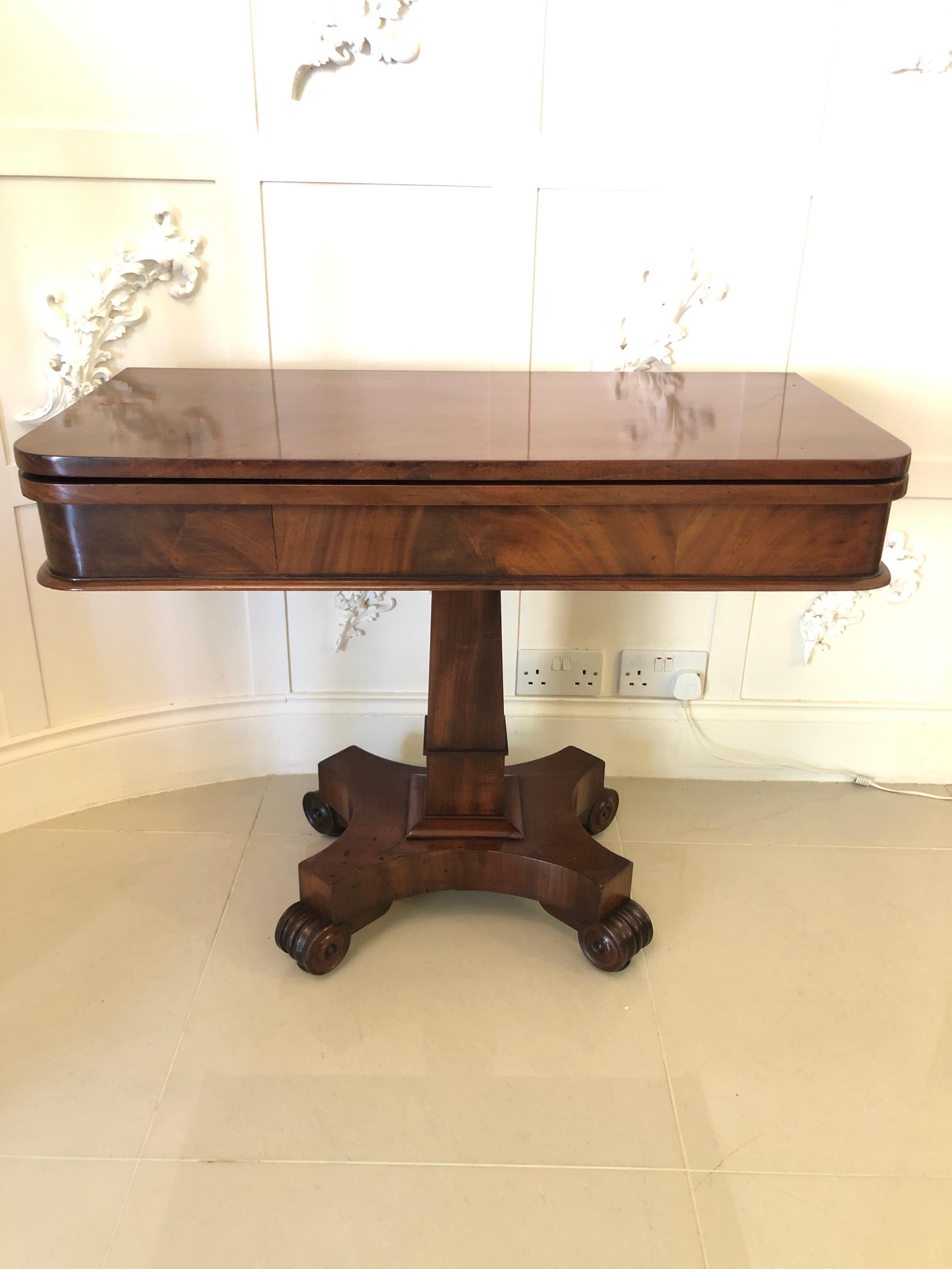 Quality antique William IV mahogany tea/side table having a marvelous mahogany round cornered swivel top opening to reveal a quality figured mahogany inside with a round cornered shaped frieze. It is raised on a square mahogany moulded pedestal and