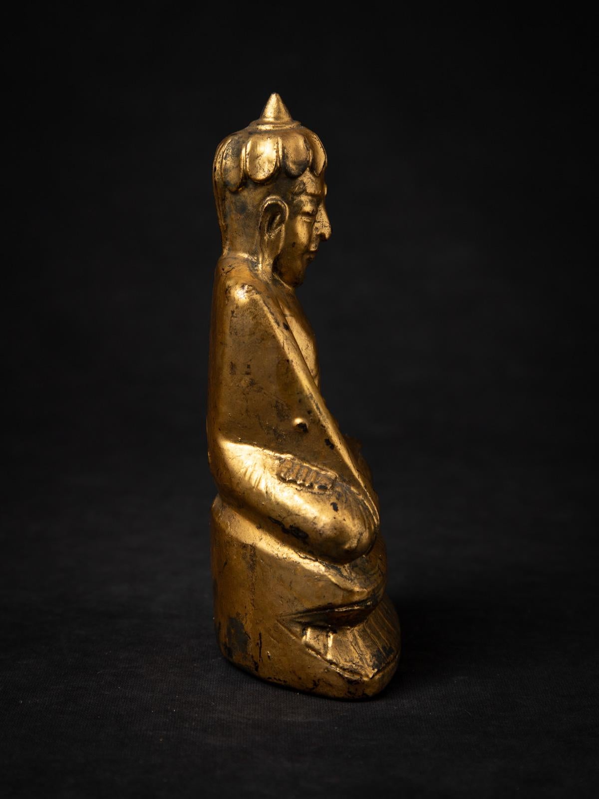 This Antique Wooden Burmese Buddha Statue, originating from Burma (Myanmar) and dating back to the 19th century, is a truly remarkable and rare artifact. Crafted from high-quality wood, the statue stands 18.5 cm high, with a width of 10.4 cm and