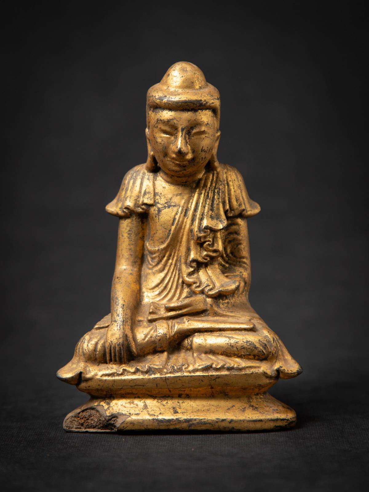 Discover this antique wooden Burmese Buddha statue, an authentic 19th-century artifact crafted in the distinctive Shan (Tai Yai) style. Made from solid wood and gilded with 24 karat gold, it depicts the Bhumisparsha mudra, symbolizing the Buddha’s