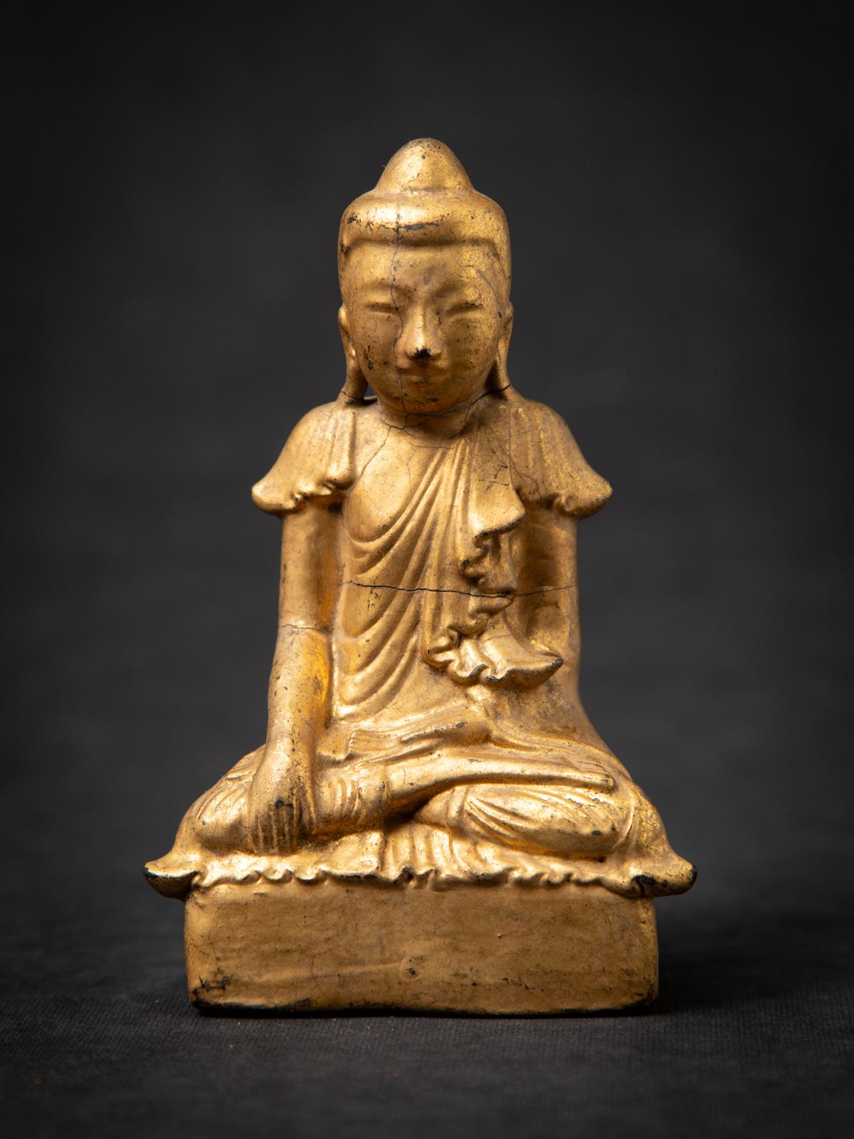 Presenting this antique wooden Burmese Buddha statue, an authentic 19th-century piece crafted in the elegant Shan (Tai Yai) style. Made from solid wood and gilded with 24 karat gold, it features the Bhumisparsha mudra, symbolizing the Buddha’s