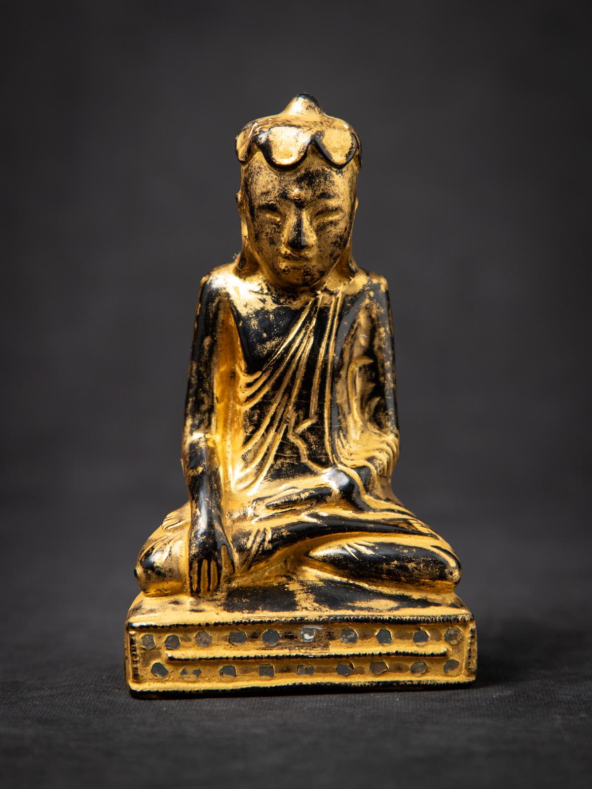 This antique wooden Burmese Buddha statue from the 19th century is a fine example of Shan (Tai Yai) style craftsmanship. Made from wood and elegantly gilded with 24 krt. gold, the statue measures 13.8 cm high, 8.1 cm wide, and 4.5 cm deep, with a