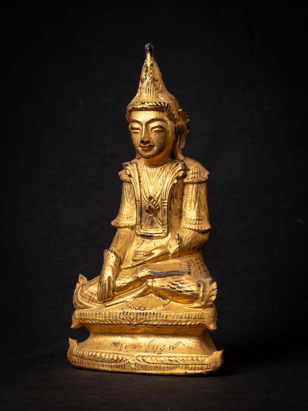 This antique wooden Burmese Buddha statue is a remarkable piece of art and spirituality. Crafted from wood, it stands at a height of 30.5 cm, with dimensions of 17 cm in width and 8.3 cm in depth. The statue is adorned with the radiant beauty of