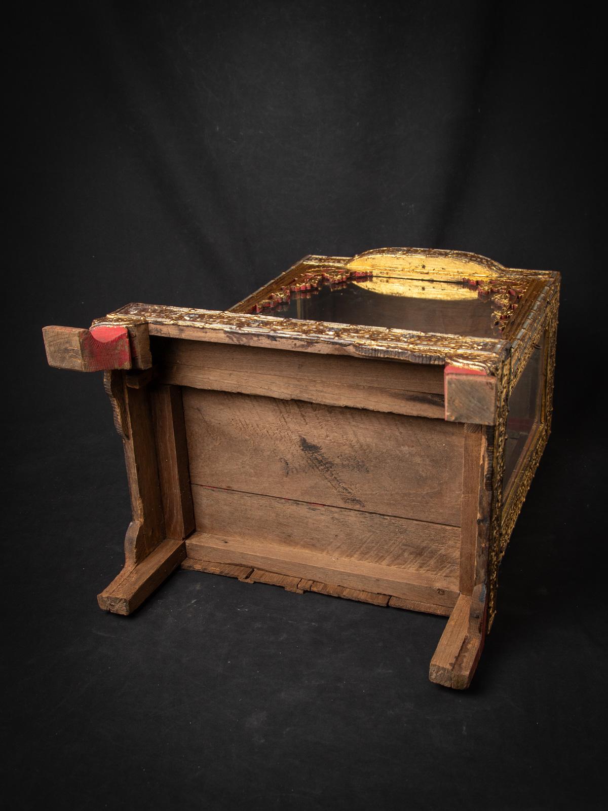 This 19th century Antique wooden Burmese Buddha temple is a stunning testament to the rich spiritual and artistic heritage of Burma. Crafted from wood and standing at a height of 63,5 cm, with dimensions of 45 cm in width and 33,3 cm in depth, it