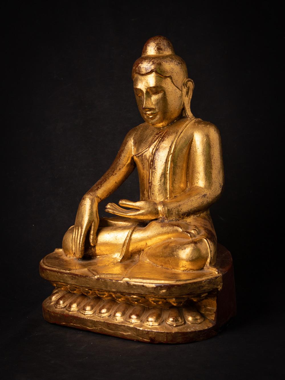 The antique wooden Burmese Lotus Buddha is a captivating and spiritually significant artifact originating from Burma. Crafted from wood and adorned with 24-karat gold gilding, this Buddha statue stands at 46 cm in height and measures 32.5 cm in
