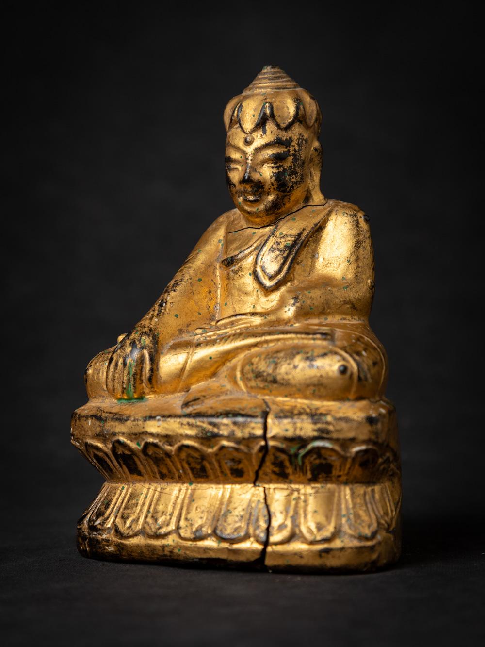 This antique wooden Burmese Lotus Buddha statue is a remarkable piece of religious artistry. Crafted from wood and standing at a height of 14.8 cm, with dimensions of 10 cm in width and 7.7 cm in depth, this statue exudes elegance.

The statue is