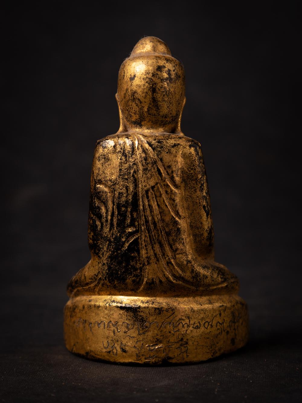 This antique wooden Burmese Buddha statue is a remarkable piece of art and spirituality. Crafted from wood, it stands at a height of 13.6 cm, with dimensions of 8 cm in width and 5 cm in depth. The statue is adorned with the radiant beauty of