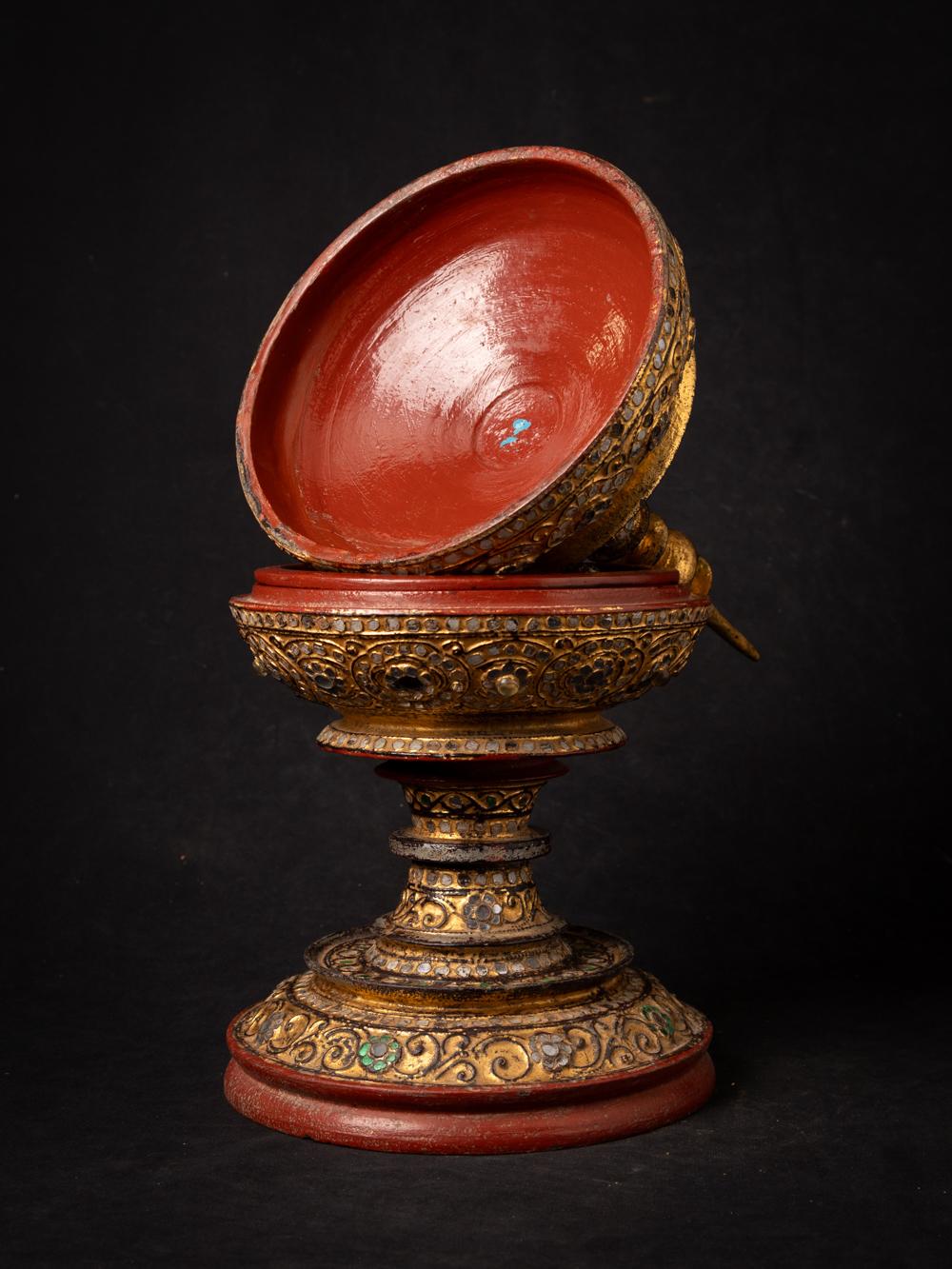 The antique wooden Burmese offering vessel is a remarkable and culturally significant artifact originating from Burma. Crafted from wood and gilded with 24-karat gold, this offering vessel stands at 49.8 cm in height and has a diameter of 20.8 cm.